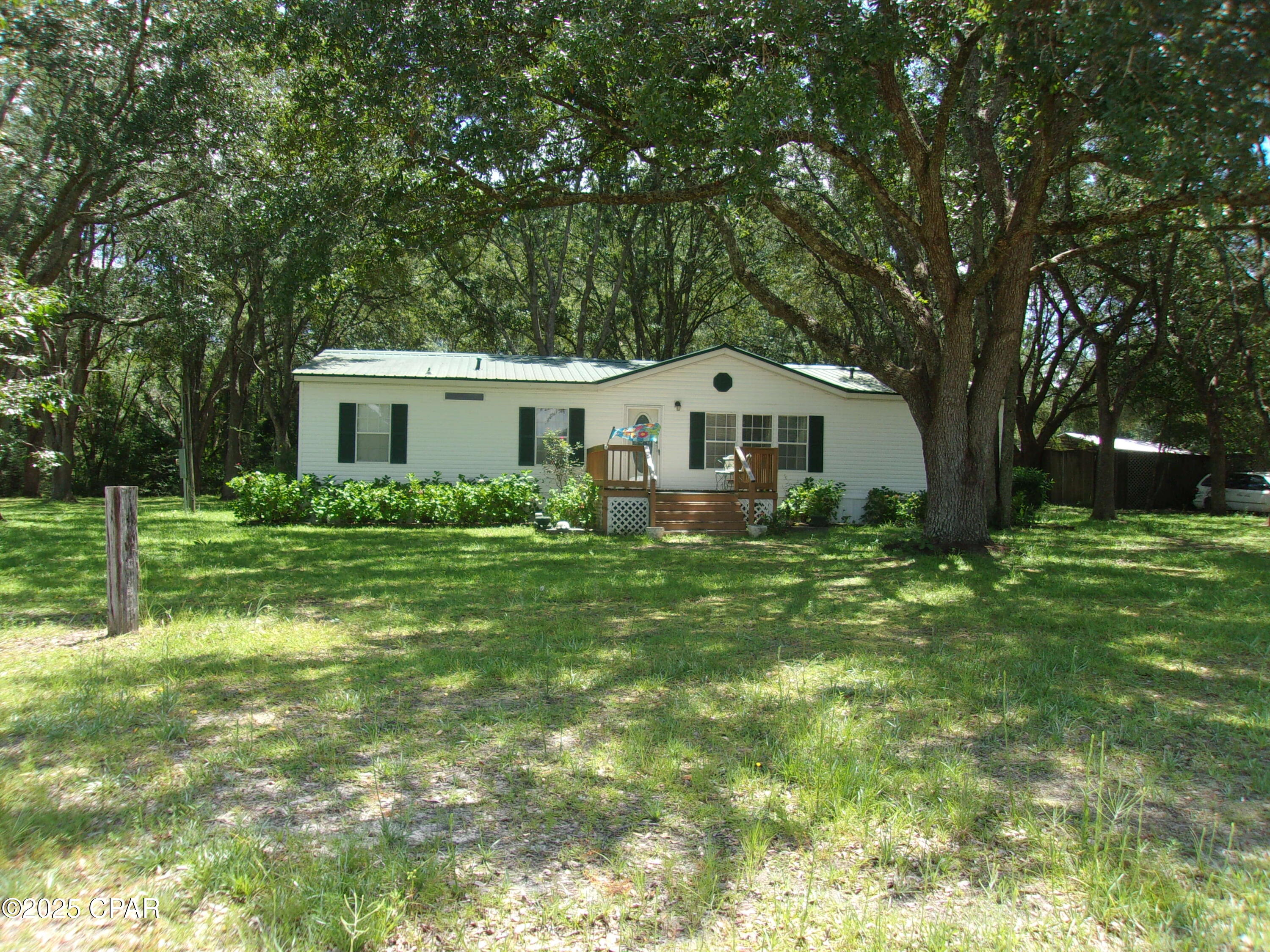 TURN-KEY! Discover this beautifully maintained and charming 3-bedroom, 2-bath doublewide mobile home nestled on a generous 1/2 acre lot. Enjoy the thoughtful split bedroom design, featuring a spacious living room that creates a warm and inviting atmosphere. The master suite boasts a sizable walk-in closet, and the master bath includes double sinks, a luxurious garden tub, and a convenient walk-in shower. Located at the edge of Ponce de Leon, Florida, this lovely home is in a tranquil area while still being just a short distance from the interstate and the world's most stunning sandy beaches. Experience peaceful country living at its finest! All furnishings are included just bring your clothes and make yourself at home. Don't miss out schedule a visit today!