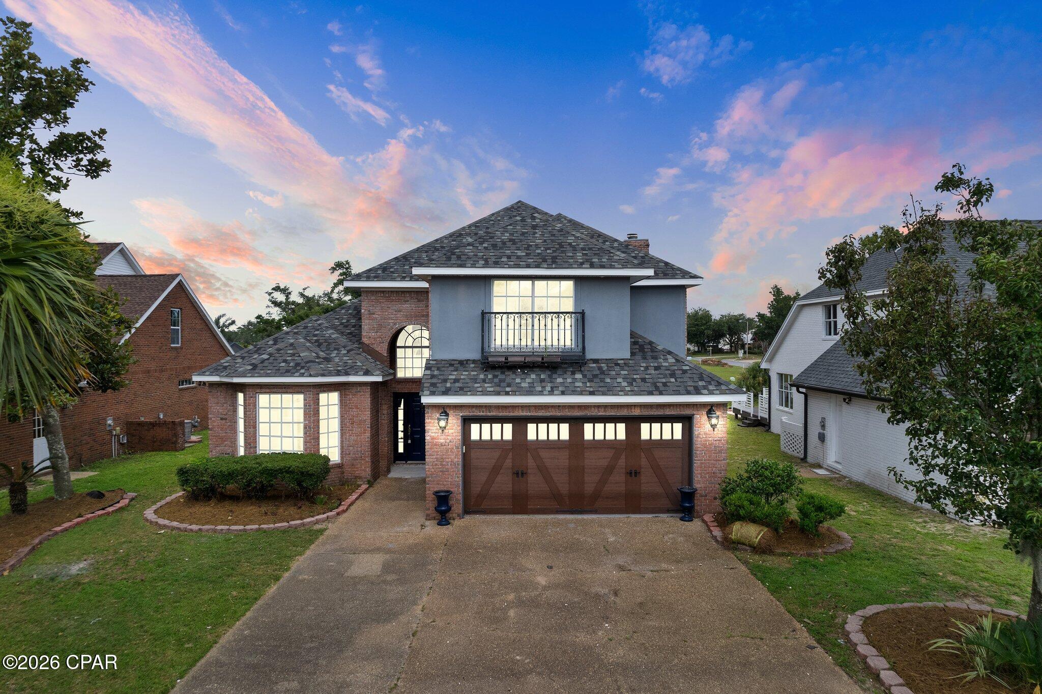 Two-story home in the prestigious Panama City Country Club community featuring a serene pond and golf course views.  The updated first floor offers spacious, flexible living areas, including an additional space ideal for a home office or formal living room, a separate formal dining area, and large backyard porch.
