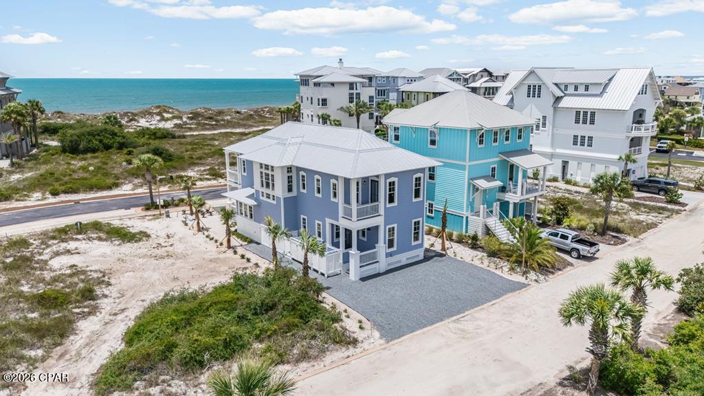 CUSTOM BUILT | X FLOOD ZONE | 2026 NEW CONSTRUCTION | GULF VIEWS Designed with both elegance and comfort in mind, this exceptional 5-bedroom, 4-bath coastal retreat showcases luxury finishes, quality craftsmanship, and upscale beachside living throughout. Located in an X Flood Zone (NO FLOOD INSURANCE REQUIRED) for added peace of mind and cost savings, this stunning home offers Gulf views and the perfect blend of style and functionality. Inside, you'll find a bright open-concept floor plan filled with natural light, soaring ceilings, and thoughtfully selected designer details. The spacious living area flows seamlessly into a gourmet kitchen featuring premium appliances, custom cabinetry, quartz countertops, and an oversized island ideal for entertaining. The primary suite offers a private escape with a spa-inspired bath, while the additional bedrooms provide ample space for guests, vacation rental potential, or multi-generational living. Every detail has been carefully designed to capture the charm and relaxed luxury of the Forgotten Coast lifestyle. Located BEACHSIDE within the exclusive gated community of Ovation, residents enjoy unmatched resort-style amenities. The Bay Club features an infinity-edge pool, fitness center, hot tub, fire pits, and scenic day docks overlooking St. Joe Bay, perfect for boating, kayaking, or simply unwinding by the water. Tennis and pickleball courts, gathering spaces, a Gulf-side pool, bathhouse, and private beach boardwalks complete the amenities. Conveniently located near St. Joseph Peninsula State Park, home to the beach once named the #1 Beach in America, residents enjoy easy access to pristine shoreline, nature trails, fishing, shelling, and endless outdoor adventure. Whether you're searching for a primary residence, second home, or investment property, this extraordinary new build offers the very best of Cape San Blas coastal living.