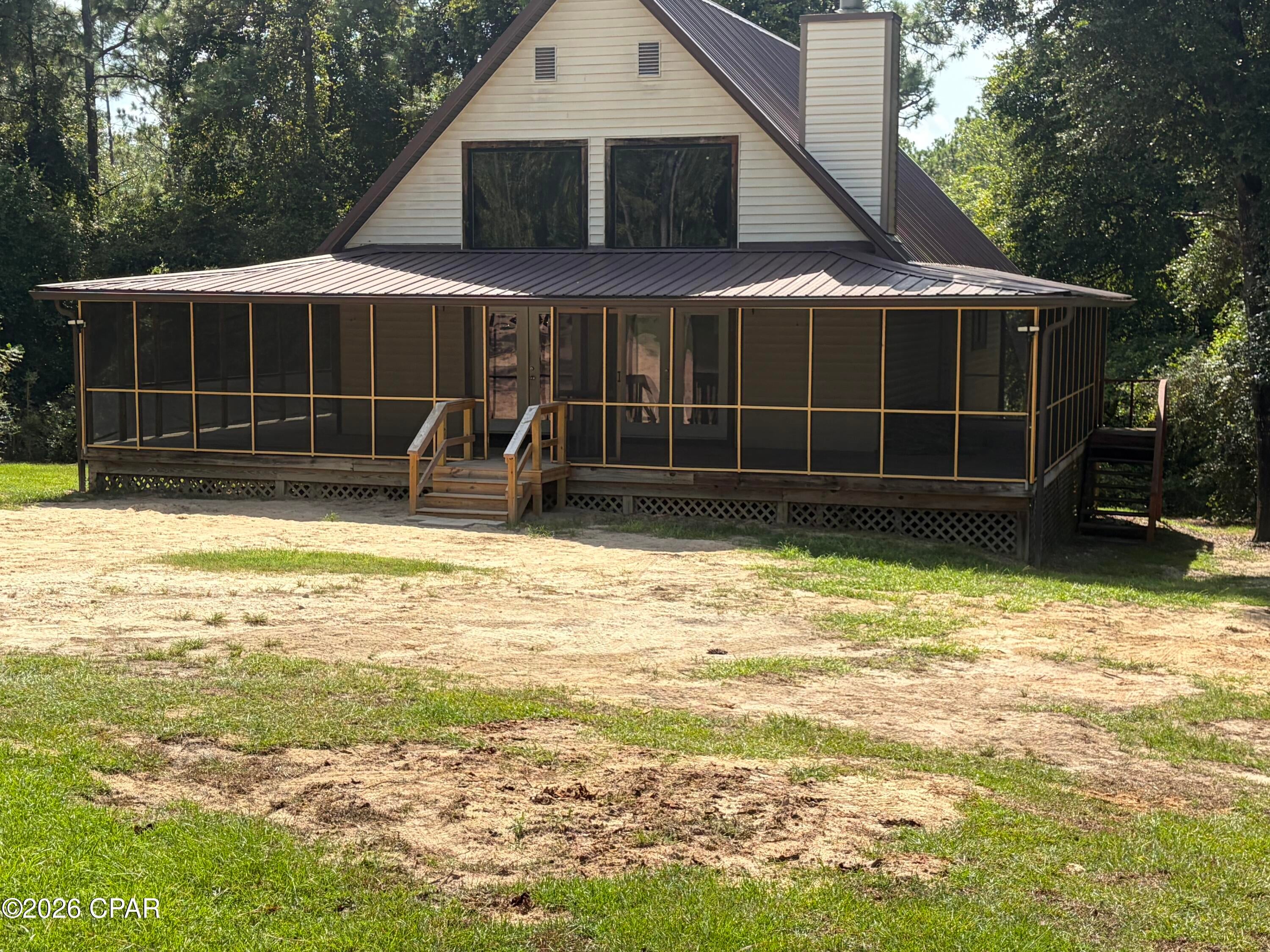 Need that little bit of Privacy and Country Setting?  This is the Home for You.  Including the Completed Basement for that 4th Bedroom and 3rd bath, this home has approximately 2,100 Sq Ft of Living Space.  If you love that Florida Living, you will love the woods surrounding the home and the stream on the back side of the property!  The large Screened porch is a great place to relax and enjoy nature.  This home has been updated with new carpet and Luxury Vinyl Plank flooring.  There are a few cool evenings that you can enjoy that woodburning Fireplace!  There is an Optional POA (Property Owners Association) but no building restrictions.  The  Optional Annual POA allows you access to a few amenities and the Club House by Compass Lake.  Call today to see this home.  It won't be on the market long!