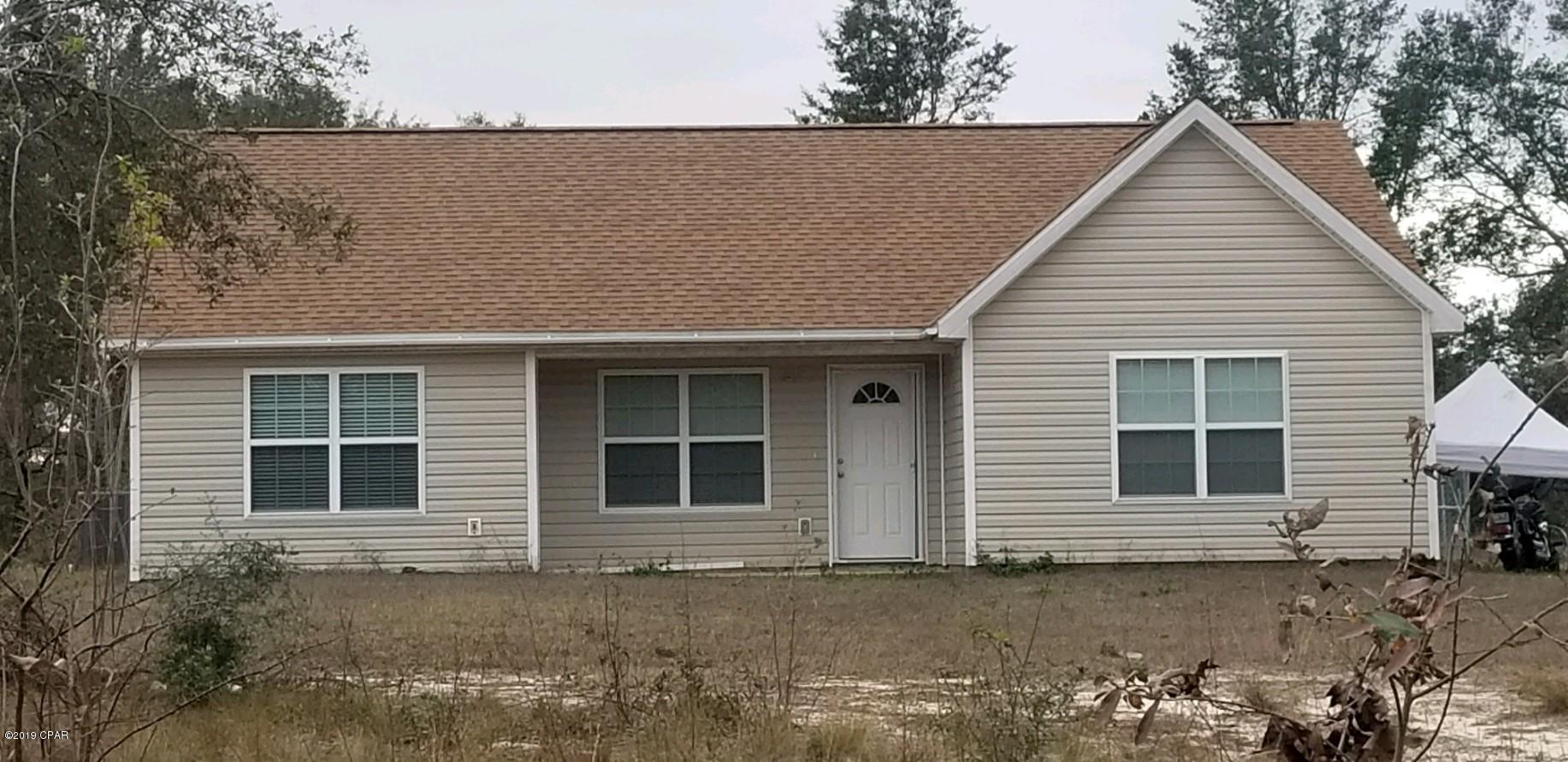 Construction on this home was completed in October 2017 in the security gated lake subdivision of Leisure Lakes. It has a split bedroom plan with a vaulted ceiling in the family room, a trey ceiling in the master bedroom, and recessed lighting throughout. The kitchen has dark self-closing cabinets and drawers, colored glass backsplash, stainless steel appliances, a panty with an etched glass door, and an island with a breakfast bar. The dining area also has a glass door for access to the back yard. Most of the house has ceramic tile that looks like wood planks, and carpet in the 3 bedrooms. There is an exit door to the outside through the utility room on one side of the house. The front porch is covered. The lot size is 2.20 acres and is flat.