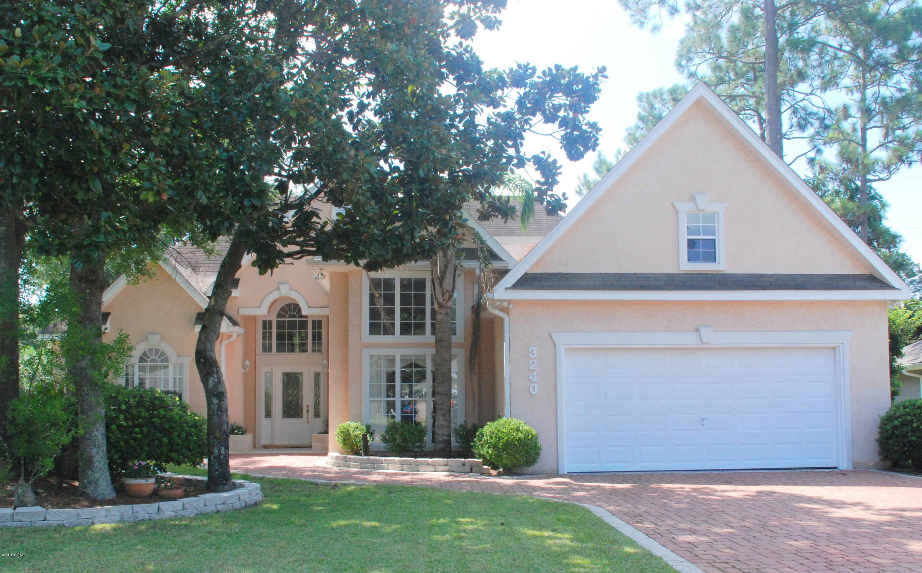 Priced below recent appraisal, this fabulous Country Club 4-bedroom, 3-bath home with a large screened pool and patio. With almost 2600 square feet of living space, this updated home is open and bright with high ceilings, crown moulding and beautiful Brazilian cherry flooring. The spacious living room overlooks the pool patio and has a fireplace. The formal dining room is an amazing 18x11 space - enough room to keep the leaves in your table year-round. The eat-in kitchen has new stainless appliances including double oven, granite counters, porcelain tile floors, a breakfast bar and lots of storage. The split bedroom plan features three bedrooms on one side of the house including the 16x16 back bedroom with its own bath and pool access which could be a second master or den. The hall bath has been wonderfully updated with a clawfoot tub, marble counters and double vanity. The Master bedroom also has the beautiful wood floors and a sitting area. The renovated Master bath has Travertine tile around the whirlpool tub and in the shower with double headed shower and body massage, walk-in closet and water closet. The back yard is a great retreat with a large enclosed pool and separate hot tub. Extra features include extra wide paver driveway, new A/C system, new Rinnai tankless water heater and for extra peace of mind, an active termite bond. Call your Realtor today for your private tour.