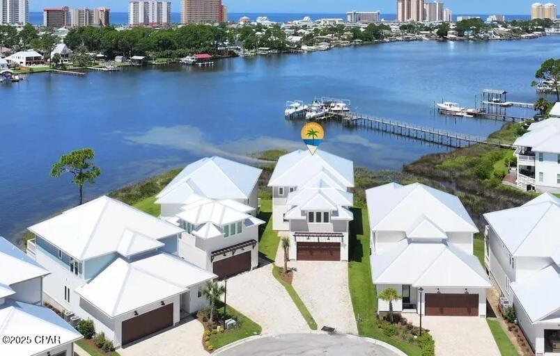 Waterfront! HOA is 600.00 a quarter. BRAND NEW 5 Bedroom waterfront home on Grand Lagoon with assigned boat slip and gated community. This huge custom home is 3890 sq feet. Home has a downstairs master bedroom with stunning water views in 3 directions. Home is move in ready. Quartz countertops, tankless gas hot water heater, and gas stove for cooking. Hurricane windows and doors. This home has a Community pool for your enjoyment. Wonderful neighborhood and people. HOA only $600.00 a quarter, which includes landscaping. Conveniently located to popular restaurants. Hop on your boat and enjoy a day of fishing and a fun at Shell Island.
