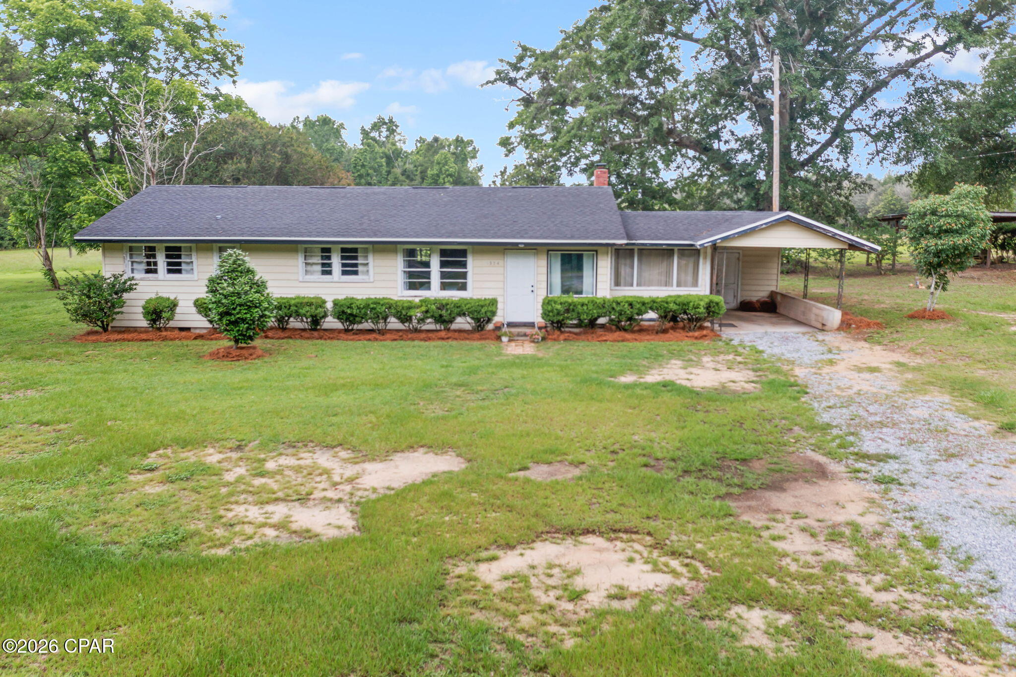 Welcome to Piney Grove Road, where country charm and peaceful surroundings come together on 2+/- acres. Nestled among mature trees and open green space, this 3-bedroom, 1-bath home offers a comfortable layout and the opportunity to enjoy the quiet lifestyle that makes this area so desirable. Inside, you'll find beautiful hardwood flooring, a spacious living room highlighted by a wood-burning fireplace, and a dedicated dining area perfect for gathering with family and friends. The updated kitchen features white cabinetry, ample counter space, and stainless-steel appliances, creating a bright and functional space for everyday living. In addition to the three bedrooms, a generous bonus room offers excellent flexibility and could serve as a playroom, home office, media room, hobby space, or be easily converted into an additional bedroom to suit your needs. Step outside and enjoy the expansive yard with plenty of room for gardening, recreation, animals, or future improvements. A covered outdoor gathering area provides the perfect spot for relaxing, entertaining, or enjoying the peaceful views of the surrounding property. Whether you're looking for a primary residence, weekend getaway, or investment opportunity, this property offers the space, setting, and versatility to make it your own.