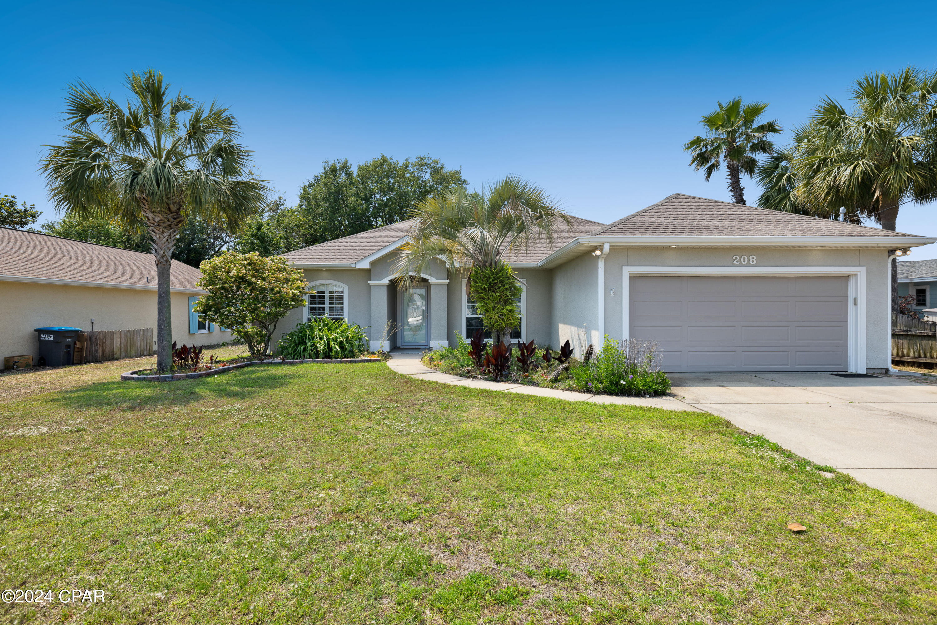 CURRENTLY UNDER CONTRACT, SELLER WILL CONSIDER BACKUP OFFERS  Welcome home!  This beautiful  home is in a high demand, centrally located, neighborhood only a half a mile to the BEACH! This home has many added details like tile floors throughout, trey lighted ceilings, granite countertops, large pantry, newer appliances include smooth top range, microwave, and refrigerator.  The open living concept makes this the perfect family home for entertaining with entertainment area and wine refrigerator in the living room.  The primary bedroom and bath are a must see...spacious bath with double sink vanity, separate shower, large jacuzzi garden tub and an amazing walk-in closet.  Enjoy outdoor entertaining and dining on your covered porch that is accessible from the living room area. Beautifully landscaped with mature palm trees. Lastly, this home features a full array of solar panels that provide the majority of the power to the home.  This home is within minutes of fine dining, Pier Park, Frank Brown Park, Sports Complex, entertainment, and most importantly THE WORLDS MOST BEAUTIFUL BEACHES!