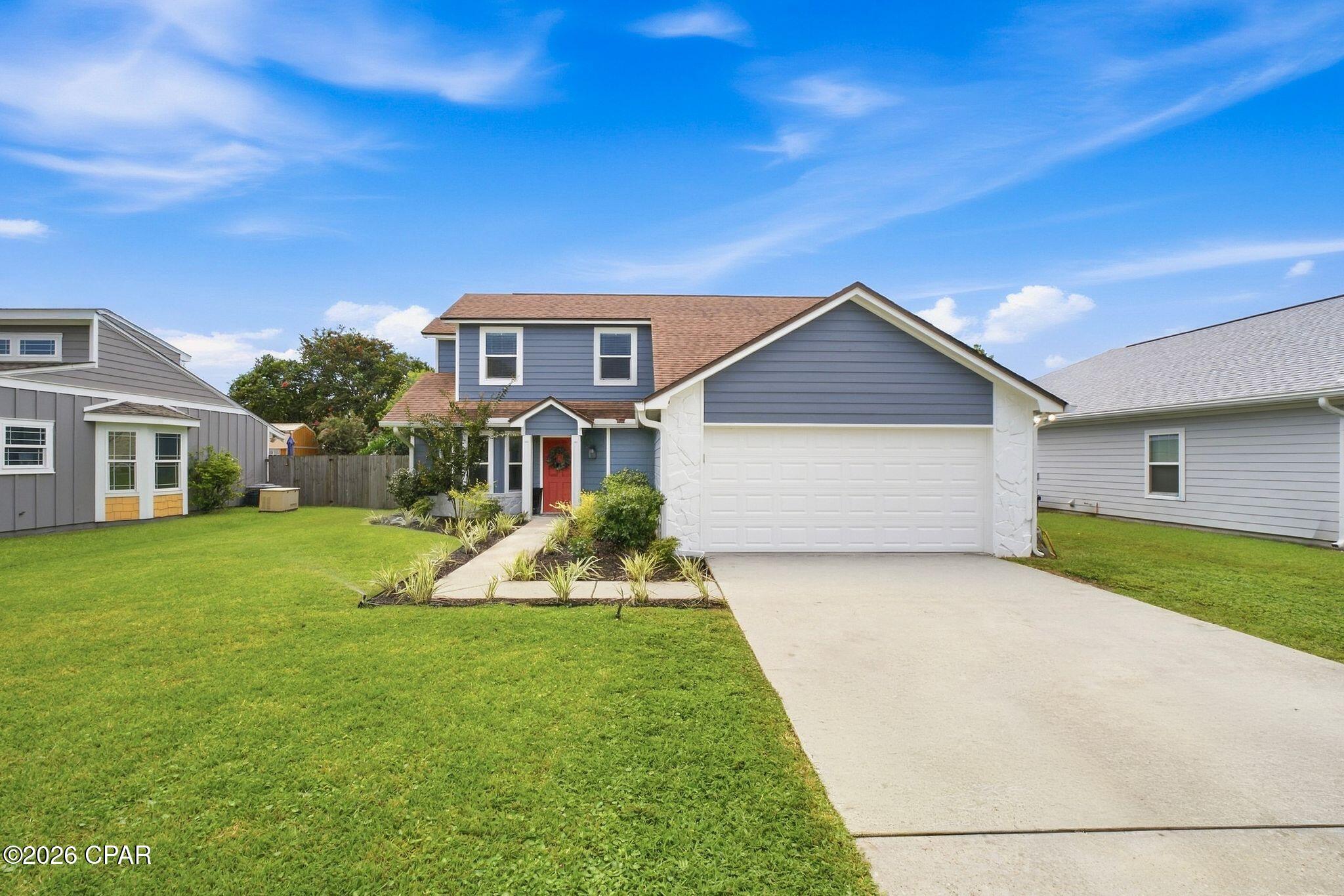 Welcome to 503 Krystal Lane, a beautifully maintained 3-bedroom, 2.5-bath two-story home in desirable Lynn Haven, offering 1,554 square feet of thoughtfully designed living space and an impressive blend of comfort, character, and custom finishes.

The spacious main level features a primary suite conveniently located downstairs, complete with vaulted ceilings, French doors, and a closet system designed to maximize storage. The living and dining areas also feature vaulted ceilings, creating an open and inviting atmosphere, while the custom fireplace and mantle serve as a beautiful focal point in the living room. A convenient half bath is located just off the garage on the first floor, making it easily accessible for guests and everyday use.

The kitchen offers granite countertops, while plank flooring throughout the first floor adds both style and durability. The home also features a whole-home water filtration system and a reverse-osmosis water filtration system with a dedicated faucet in the kitchen. Upstairs, you'll find two additional bedrooms and a full bathroom, providing plenty of space for family, guests, or a home office.

Attention to detail can be found throughout the home with custom trim work and thoughtful finishes that add character and charm. French doors provide easy access to the backyard, which features a large rear patio perfect for entertaining, outdoor dining, gatherings, or simply enjoying the Florida lifestyle. The home also boasts beautiful new landscaping throughout the front and side yards, adding to its curb appeal. An impressive 8'x16' shed conveys with the sale, offering plenty of additional storage or workspace.

The garage features a custom gym setup that is negotiable, giving the next owner the opportunity to enjoy a ready-made home fitness space or transform the area to fit their needs.

503 Krystal Lane offers a fantastic combination of location, functionality, and custom touches. With its spacious layout, beautiful finishes, and thoughtful extras, this home is one you won't want to miss!