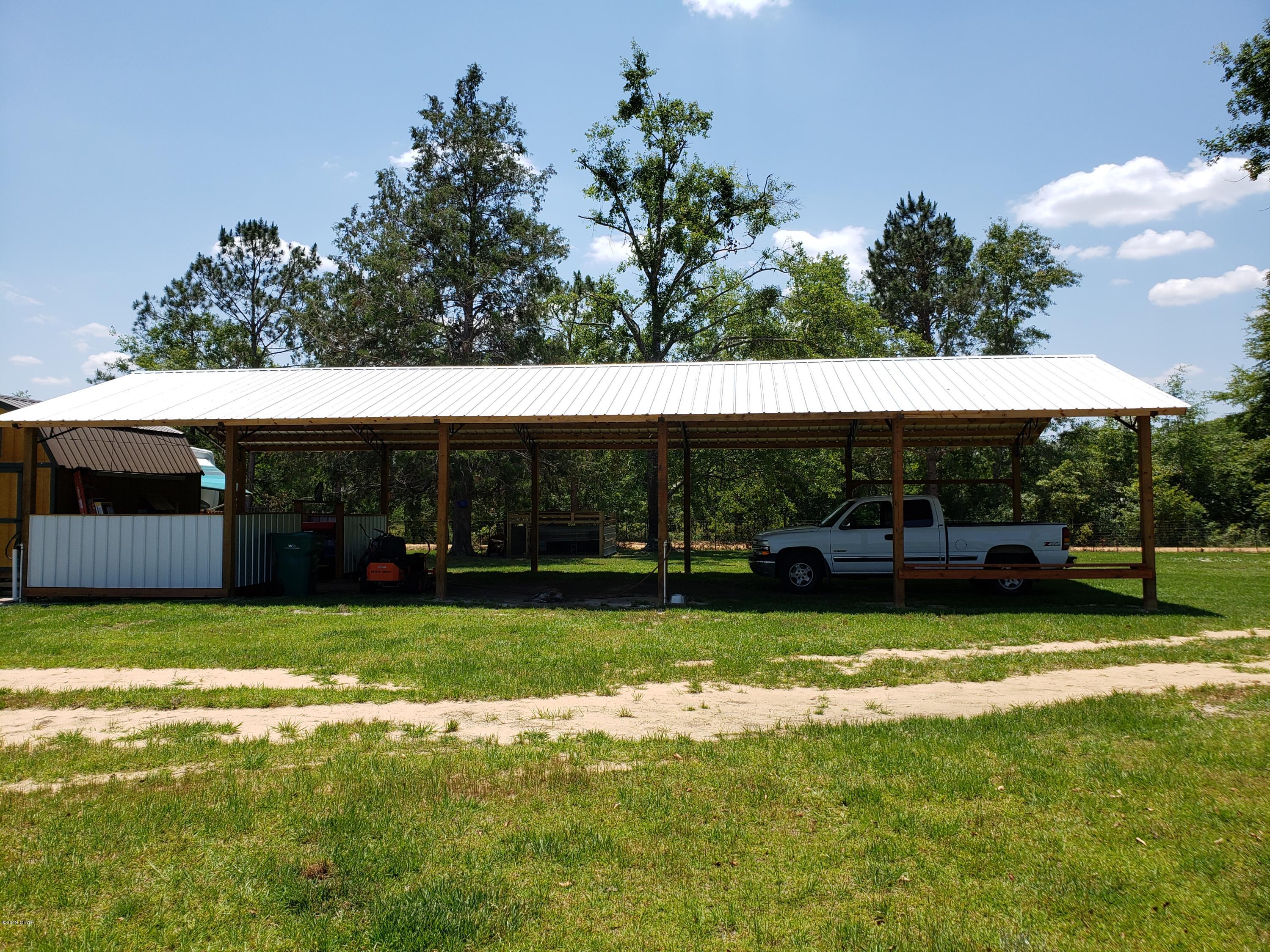 CURRENTLY UNDER CONTRACT,. SELLER WILL ACCEPT BACK UP OFFERS  Ready for you! Beautiful 4.8+/- acre parcel on the corner of Wildwood Cir and Joiner Rd in Chipley.  Property is cleared with a well, septic and power pole. Perfect for your new home or mobile home. 24x60 pole barn in place with area for storage and outside shower. 10x16 outbuilding with a loft.  Property is fenced with the front having a stocked pond, cross fenced for animals with water available. Peaceful country setting not far from town. Approx. 45 minutes to Panama City Beach to the south and Dothan, AL to the north.