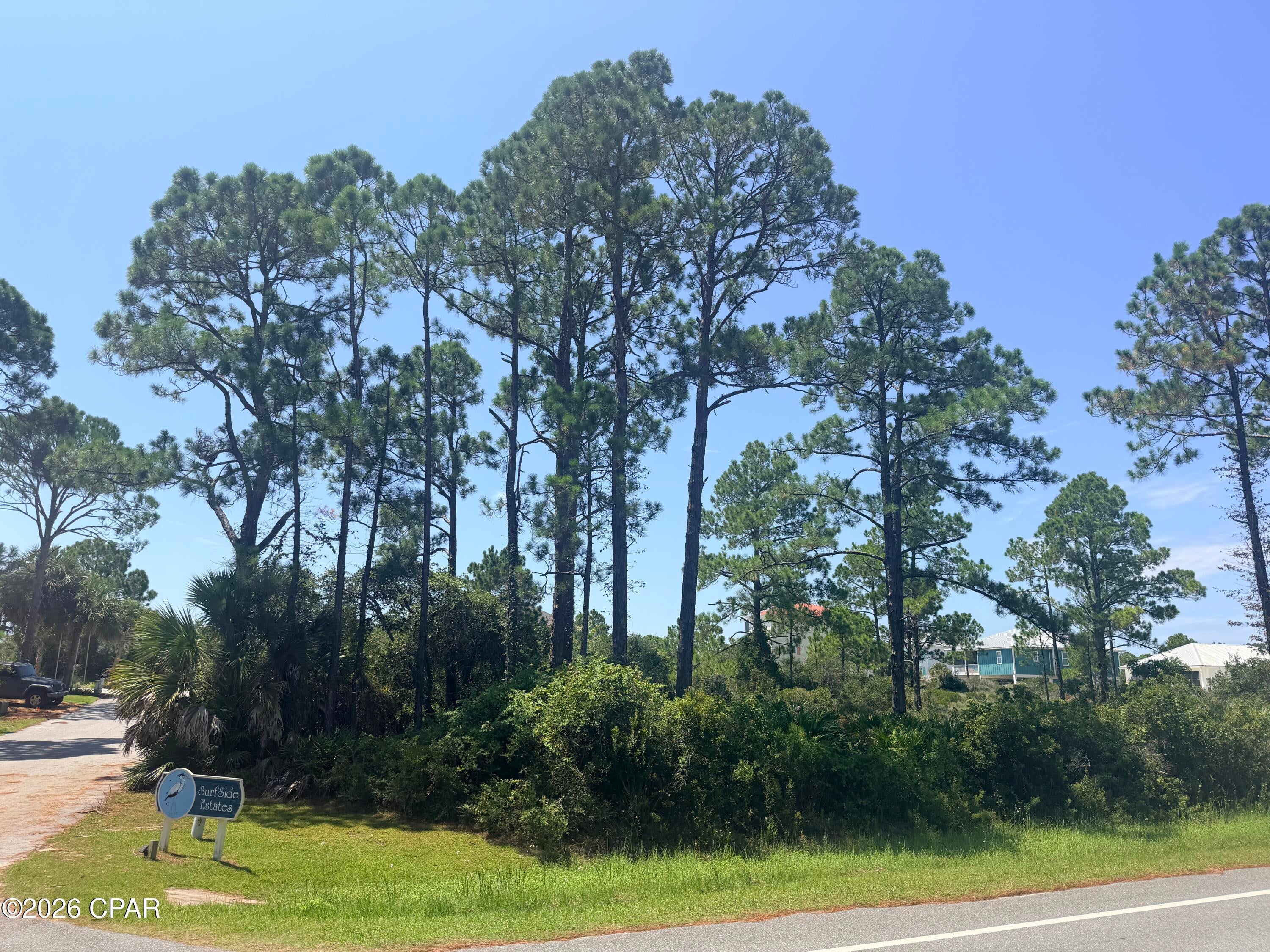 NATURE MEETS COAST!! Coastal living begins here on Cape San Blas! Discover the perfect place to build your dream beach retreat on this beautiful, heavily wooded corner lot nestled in the desirable Surfside Estates community. Elevated for added appeal, this exceptional homesite offers partial views of St. Joseph Bay, convenient beach access, & the rare opportunity to enjoy the best of both the Gulf of Mexico & St. Joseph Bay from one incredible location. Towering native oaks & lush coastal vegetation create a private, peaceful setting filled with the timeless charm of Old Florida, while available utilities make it easy to begin planning your custom coastal escape. Whether you're searching for a full-time residence, vacation getaway, or investment opportunity, this property checks all the boxes. A well-maintained public boardwalk provides easy pedestrian access to the sugar-white beaches where you can spend your days swimming, shelling, fishing, paddleboarding, or simply relaxing to the sound of the surf. Even better, the dog-friendly beach allows your four-legged family members to enjoy the coastal lifestyle right alongside you. Just a short walk away, the crystal-clear waters of St. Joseph Bay offer endless opportunities for kayaking, paddleboarding, world-class fishing, scalloping, & breathtaking sunrise views. Approximately two-thirds of a mile from the property, Salinas Park features outstanding amenities including newly constructed pickleball courts, an observation pier extending into the bay, scenic bayfront walking trails, Gulf-front beach access, picnic areas, & open green spaces perfect for enjoying the area's natural beauty. Across the street, a paved biking & running path winds the length of Cape San Blas, making morning jogs, leisurely bike rides, & evening strolls part of your everyday routine. Renowned for its uncrowded beaches, exceptional fishing, boating, abundant wildlife, & unforgettable sunsets, Cape San Blas offers the relaxed coastal lifestyle you've been dreaming of. Enjoy the peace & privacy of this quiet beachside community while being just a short drive from historic downtown Port St. Joe, where you'll find waterfront dining, boutique shopping, local marinas, live entertainment, festivals, parks, & everything that makes this charming coastal town so special. Opportunities to own an elevated, wooded corner lot with partial bay views, easy beach access, & outstanding recreational amenities at such an attractive price are becoming increasingly rare. Build the coastal home you've always imagined & start making memories that will last a lifetime along Florida's beautiful Forgotten Coast. Call for your private tour & LIVE THE BEACH LIFE!
