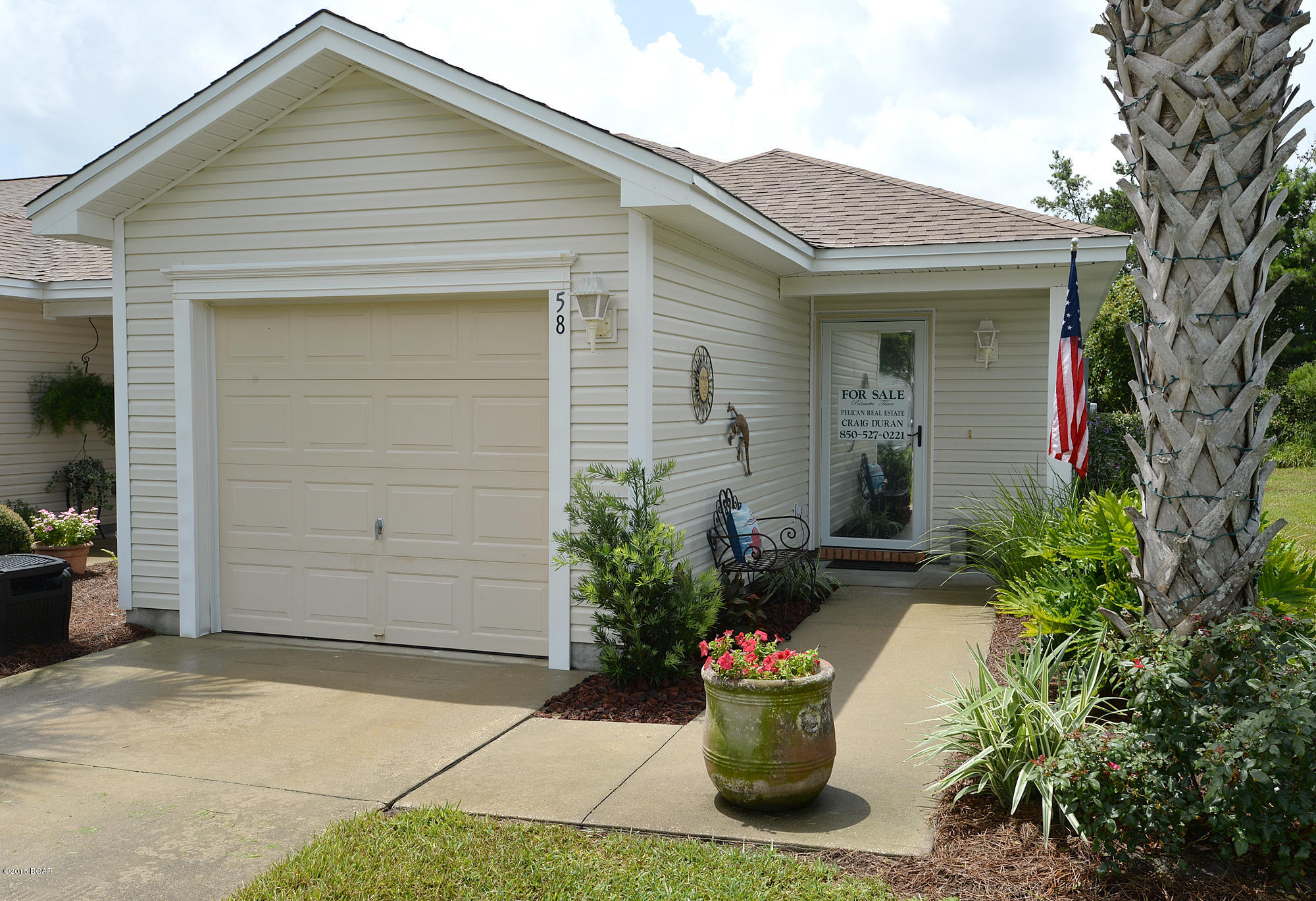 **GORGEOUS END UNIT**  This wonderful town home is in remarkable condition.  The owners live there and have taken remarkable pride in owning and it shows.  The beautiful wood floors were installed not quite two years ago and really add a touch of class.  All of the appliances are less than two years old and the owners have the HVAC serviced twice annually.   They tinted all of the windows that take direct sunlight for comfort and lower energy bills.  Enjoy morning coffee or read a book on the private, oversized, screened in patio while knowing that there are no neighbors on one side.  On street parking is not allowed in Palmetto Trace and this just may be the longest driveway in the neighborhood.  Park one car in the garage and 4-5 in the LONG, extended driveway. Take your weekends back knowing that the yard is maintained by the HOA...or maybe you are already retired...even better.  These fantastic town homes in Palmetto Trace do not last long, especially ones in this condition and with this kind of privacy and parking.  Call today to take a look.