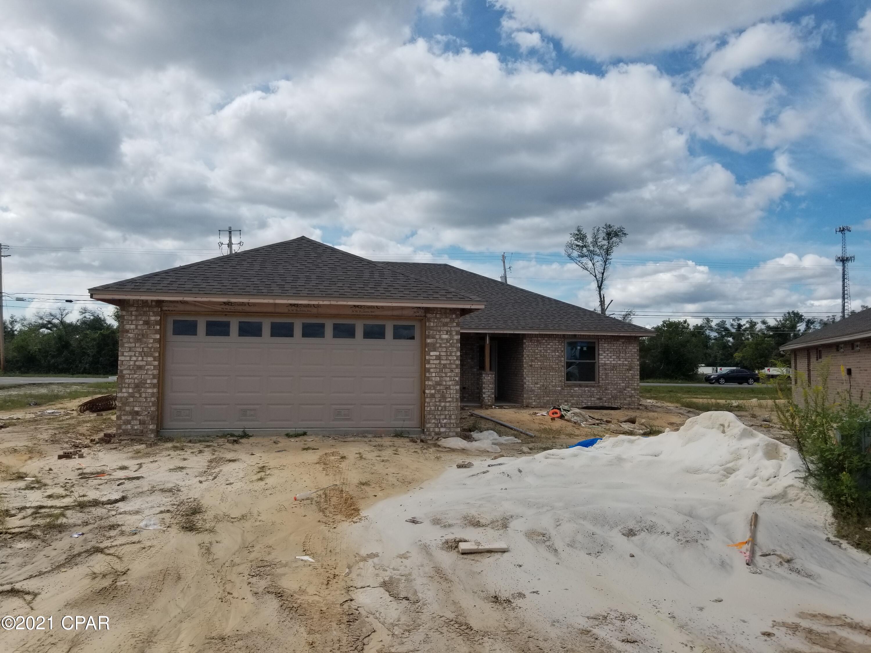 Under construction ,This well built 3 bedroom 2 bath all brick home that offers large open floor plan, master bath with his & hers double shower with Rain maker (3 shower heads) and shower bench, double vanity, large master bedroom with built-in rope lighting, separate office room and large walk-in closets. The kitchen is a dream with all real hard wood white cabinets, granite countertops, stainless steel appliances, cabinets in the laundry room. Living room with high tray ceilings with electric fire place, crown molding and wired for todays entertainment. Home comes with large Florida room, front porch, and open back porch, security system, thermoseal spry foam system and generator ready electrical outlet with cord. outside shower and sprinkler system.