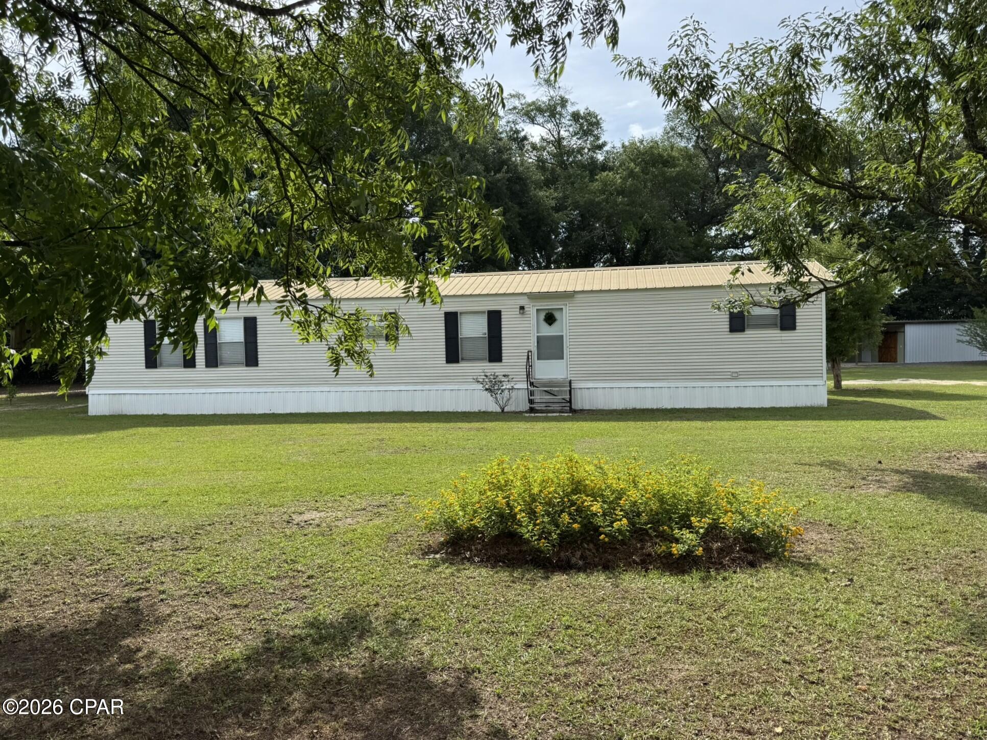 Escape to peaceful country living with this well-maintained 3 bedroom, 2 bath single wide mobile home nestled on gorgeous acreage in a rural setting on a paved road. This property offers the perfect blend of privacy, functionality, and outdoor charm.
Outside you'll find an impressive 25x24 barn featuring beautiful country-style sliding barn doors. The barn is thoughtfully divided into two sections -- one side includes a window A/C unit ideal for hobbies, a workshop, or tool storage, while the other side provides plenty of room for lawn equipment, mowers, and outdoor gear.
There is also an additional 20x12 shed with electricity, including a 220 outlet, offering even more flexibility for projects or storage needs.
For outdoor enthusiasts, the property also includes a concrete hunter's cleaning station. Nature lovers will appreciate the mature fruit trees, including plum trees that produce some of the sweetest plums you'll ever taste, along with a couple of thriving Satsuma trees.
Additional features include:
• HVAC approximately 12 years old
• Hot water heater approximately 4 years old
• Rural setting with beautiful acreage
• Paved road frontage
Please note: the dark grey shed shown in photos does not convey with the property.
