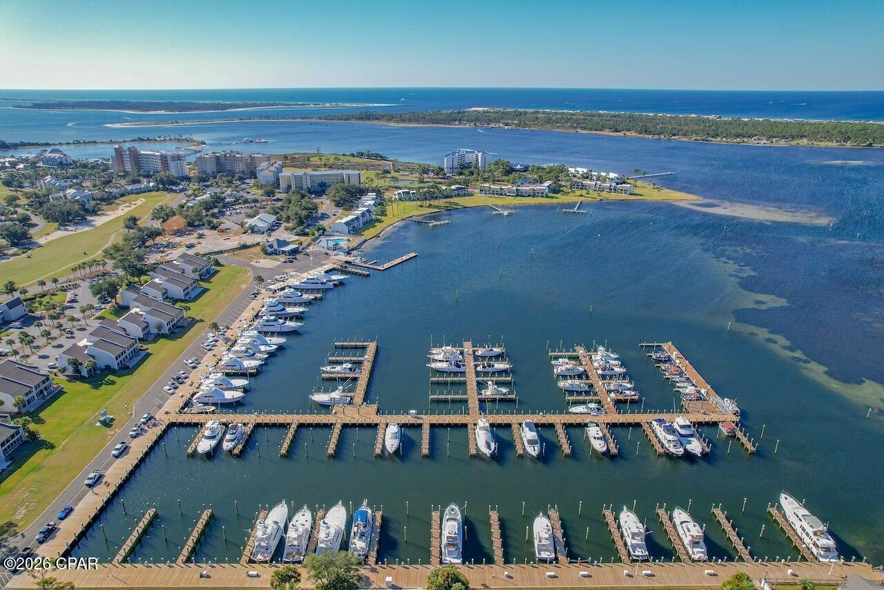 Waterfront Views & Beautifully Appointed Bay Point Condo

Welcome to Harbour Villas at Bay Point, where breathtaking water views, resort-style amenities, and an exceptional location come together to create the perfect Panama City Beach retreat. This beautifully appointed 1-bedroom, 1-bath condo offers spectacular panoramic views overlooking Point South Marina and the Upper Grand Lagoon, with stunning sunsets right outside your door.

The condo features an impressive renovation completed by the previous owner, with quality finishes and thoughtful design throughout. The kitchen showcases shaker-style cabinetry, custom countertops, a striking black tile backsplash, stainless steel appliances, a custom island with quartz countertop, and beautiful floating shelves. The spacious bedroom offers recessed lighting and a custom accent wall with detailed carpentry, while the beautifully finished bathroom features a double vanity with a distinctive blue quartz countertop, large walk-in shower, vessel tub, and elegant 12x24 marble tile.

Just off the living area, a tucked-away sleeping nook provides an additional flexible space for overnight guests. The previous owners utilized the space with a trundle-style sleeper, making it a great option for guests or a cozy retreat without sacrificing the openness of the living area.

The current owners have added their own beautiful finishing touch with high-end plantation shutters, providing both style and functionality while complementing the condo's coastal aesthetic.

The condo is being sold unfurnished, giving the new owner the opportunity to bring their own furnishings and personal style to this exceptional waterfront retreat.

Whether you're searching for a second home, a peaceful coastal getaway, or an investment opportunity, this condo offers an incredible combination of location, water views, beautiful finishes, and Bay Point amenities. Boating enthusiasts will appreciate the marina lifestyle and easy access to the water, while the panoramic views provide a spectacular backdrop for everyday living.

Bay Point is a gated community with 24/7 roving security and is home to the Nicklaus Golf Course and Sheraton Resort. Come experience the best of Panama City Beach from a condo that combines beautiful water views, an enviable location, and a relaxed coastal lifestyle. This is a wonderful opportunity to own a special piece of Bay Point.