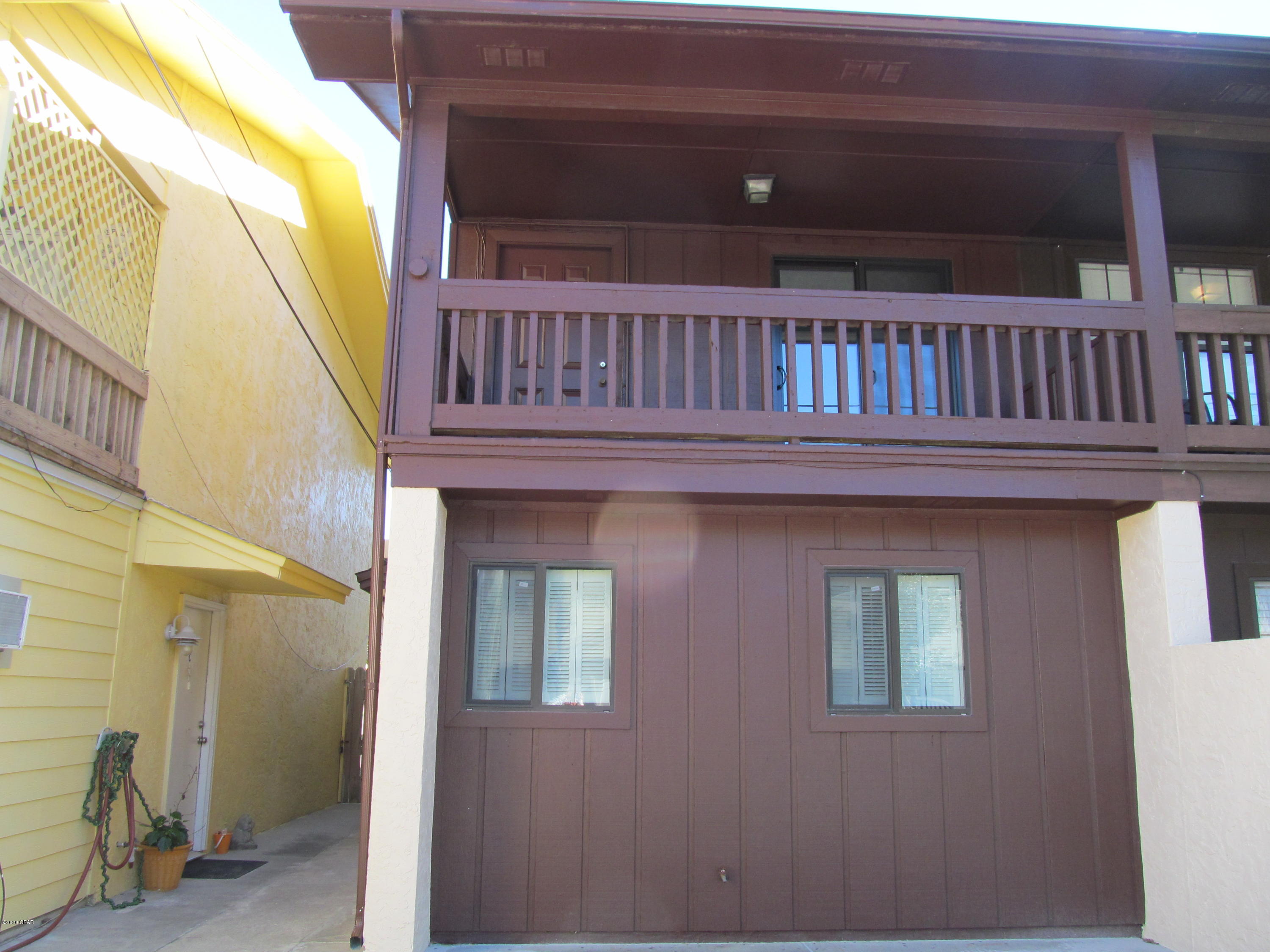 2 bedroom, 2 bath end townhouse located within walking distance to the beach. Property features bedrooms and full bath downstairs, combo living/dining room, kitchen, laundry and balcony upstairs.  Fenced backyard. Property is on septic system. Limited parking.	NO PETS