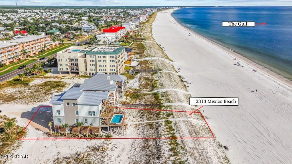 BEACHFRONT ESCAPE IN MEXICO BEACH!! This stunning 3-story retreat has been thoughtfully designed to host large groups while delivering luxury, comfort & unforgettable Gulf views. With direct beach access, a raised heated pool & elegant indoor/outdoor living spaces, every moment here feels like a postcard come to life.  Inside, the home balances privacy & togetherness with a convenient elevator and a smart floor plan. Many bedrooms open directly to decks, while the main living area flows seamlessly to the kitchen & dining space, perfect for alfresco meals with ocean breezes. Expansive windows frame the shoreline, filling the interiors with natural light & capturing the ever-changing colors of the Gulf. Spacious suites & bunk rooms ensure everyone has a comfortable place to retreat after a day on the beach. Step outside & the property truly shines: the elevated private pool overlooks the shoreline, while sandy beach access lets you stroll straight to the surf. Multiple decks provide the ideal setting for sunrise coffee, sunset cocktails, or starry nights. Fire up the grill for an evening cookout, gather family for games by the pool, or simply unwind as the sound of the waves drift through the air. Whether lounging by the pool, sinking your toes in the sand, or relaxing indoors with panoramic views, every moment here invites you to slow down & soak it all in. Life in Mexico Beach is laid-back & effortless, where sun-drenched days & salty breezes set the rhythm. Hop in your golf cart to cruise to local shops, grab fresh seafood, or glide straight to the beach — everything you need is just a quick ride away. This is more than a home; it's a lifestyle defined by simple pleasures, endless horizons & unforgettable memories made by the sea. Call for your private tour & LIVE THE BEACH LIFE!