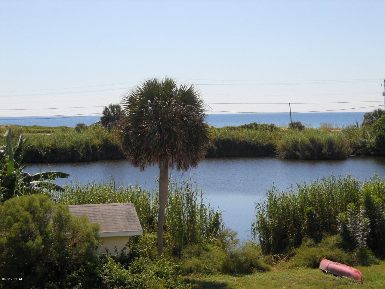Lovely rare Lakefront vacant residential lot with beautiful unobstructed Gulf views on the quiet west end of Panama City Beach! This property sits high and dry with approx 53ft waterfront on Riviera Lake, and is one of only a few on the water, this close to the beach, which looks out over the lake and over the Gulf of Mexico. Property even already has a boathouse ready to go! Beach access #86 and all that the beach has to offer is just a short walk away. 

With no HOA fees or build-out times, you have all the time you need to build what you'd like! Gulf views from the first floor. Lovely home site...!