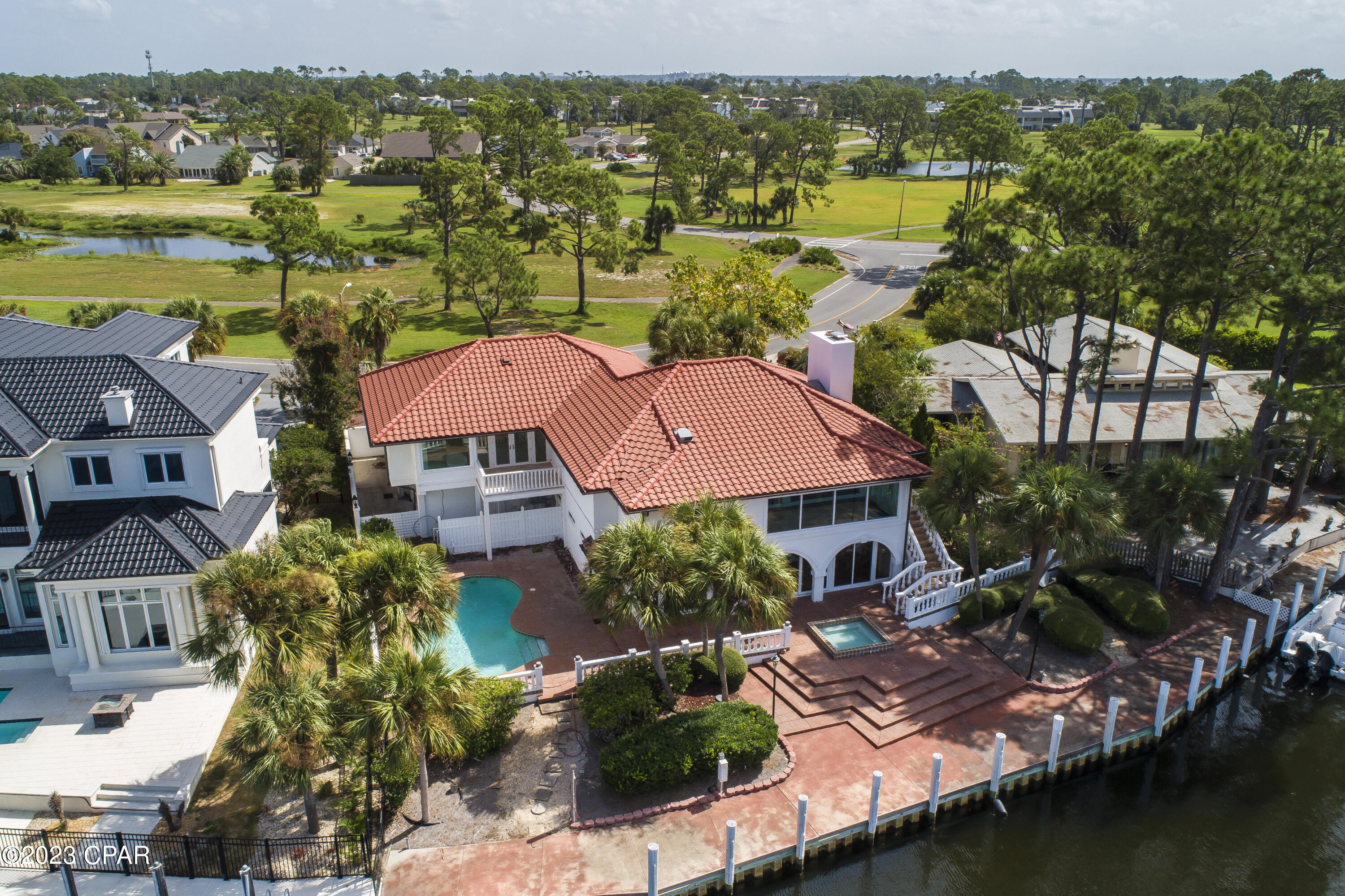 Welcome home to your coastal retreat. Imagine uninterrupted Grand Lagoon views and being able to park your boat in your backyard on a private 110ft dock. Unparalleled water views from nearly every room in the home. A thoughtful and complete renovation while also preserving the charm of custom finishes. Offering duel kitchens and top of the line Viking and Subzero appliance packages. Exterior improvements include a new roof, plumbing fixtures and electrical throughout. This stunning Master bedroom and bathroom gives all the spa like feelings featuring beautiful marble floors and walls, duel bathrooms and closets, a steam shower and separate soaking bathtub with a fireplace and bay view! (see additional remarks) Boasting natural light and vaulted ceilings, the second floor has two guest suites that are private and spacious offering en-suite baths. There is another full kitchen on this floor with custom appliances and formal dining area. Or dine al fresco in the expansive outdoor living and dining areas. This waterfront backyard is perfect for entertaining showcasing multiple lounge areas, a private dock, large private pool and separate spa. The two garage provides private parking with the drive offering spaces for up to 7 vehicles. Bay Point is a resort community providing an experience like no other. Enjoy the privacy and security of a gated and waterfront community, with a beautiful marina, golf course, restaurants, spa and fitness center. There are countless water activities to enjoy year round... pickle ball, tennis, golf, paddle boarding, boating, fishing, kayaking... there are amenities for all ages to enjoy! Welcome home. Please contact us for a private tour.
