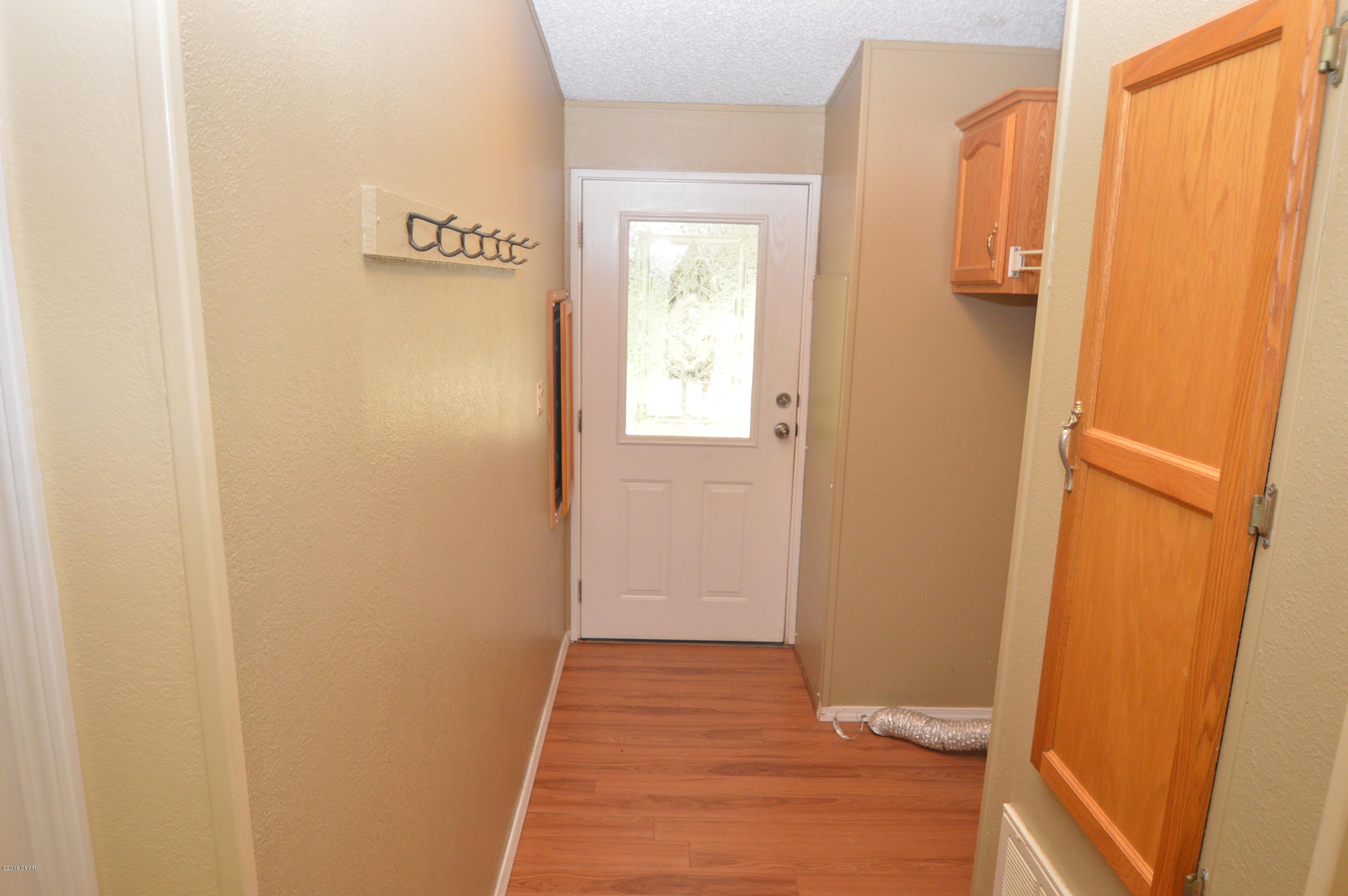 Seller is a Licensed Florida Real Estate Agent. Check out this well maintained 3bed/2 bath home on a 3.5 acre parcel that features an attached 2 car car-port, screened in sitting area, picturesque wooded driveway, beautiful pool, finished workshop, Large outbuilding with a massive concrete slab and outdoor cooking area, greenhouse, Massive storage barn with 4 large parking bays, stocked fishing pond, Shaded Gazebo area with outdoor swings, and a Handicap accessible front porch, and 2 wells. This home has been meticulously maintained and updated over the years. The open floor plan and recently installed plank flooring throughout makes it feel very large. The kitchen is loaded with tons of cabinetry, stainless steel appliances, under cabinet lighting, and large amount of counter/prep space. The large living space features a gas log fireplace, chair rail molding, and plenty of room to entertain all of your guest. The 13x13 master has a great closet with plenty of built in storage and a shoe rack. The master suite has a double vanity, shower, and a large tub with jets. This quiet location just outside of town gives you plenty of room for animals and privacy, with a short drive into town. This home offers so much for a home in this price range!