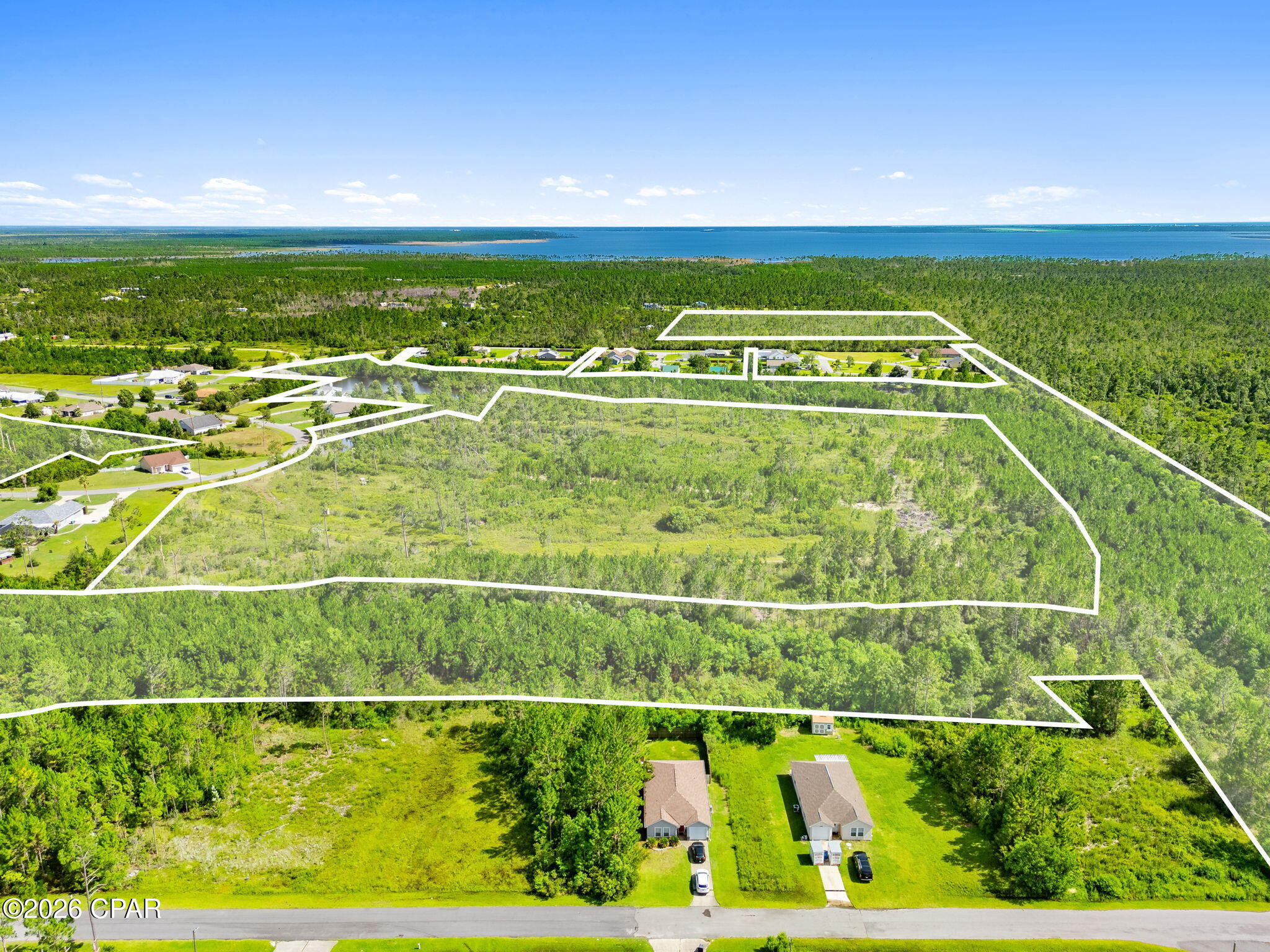 Exceptional development opportunity in Sandy Creek Country Club. These five parcels comprise approximately 70 acres and offer substantial potential for a residential development or investment project. With ample acreage and an established subdivision setting, the property presents an opportunity to create additional homesites within an existing community. The parcels are being offered together and include Bay County parcel numbers 07400-892-000, 07400-898-000, 07400-895-000, 07399-000-000, and 07400-899-000. Buyer should independently verify acreage, zoning, land-use designations, utility availability, development requirements, environmental conditions, and intended use with the appropriate governing authorities.