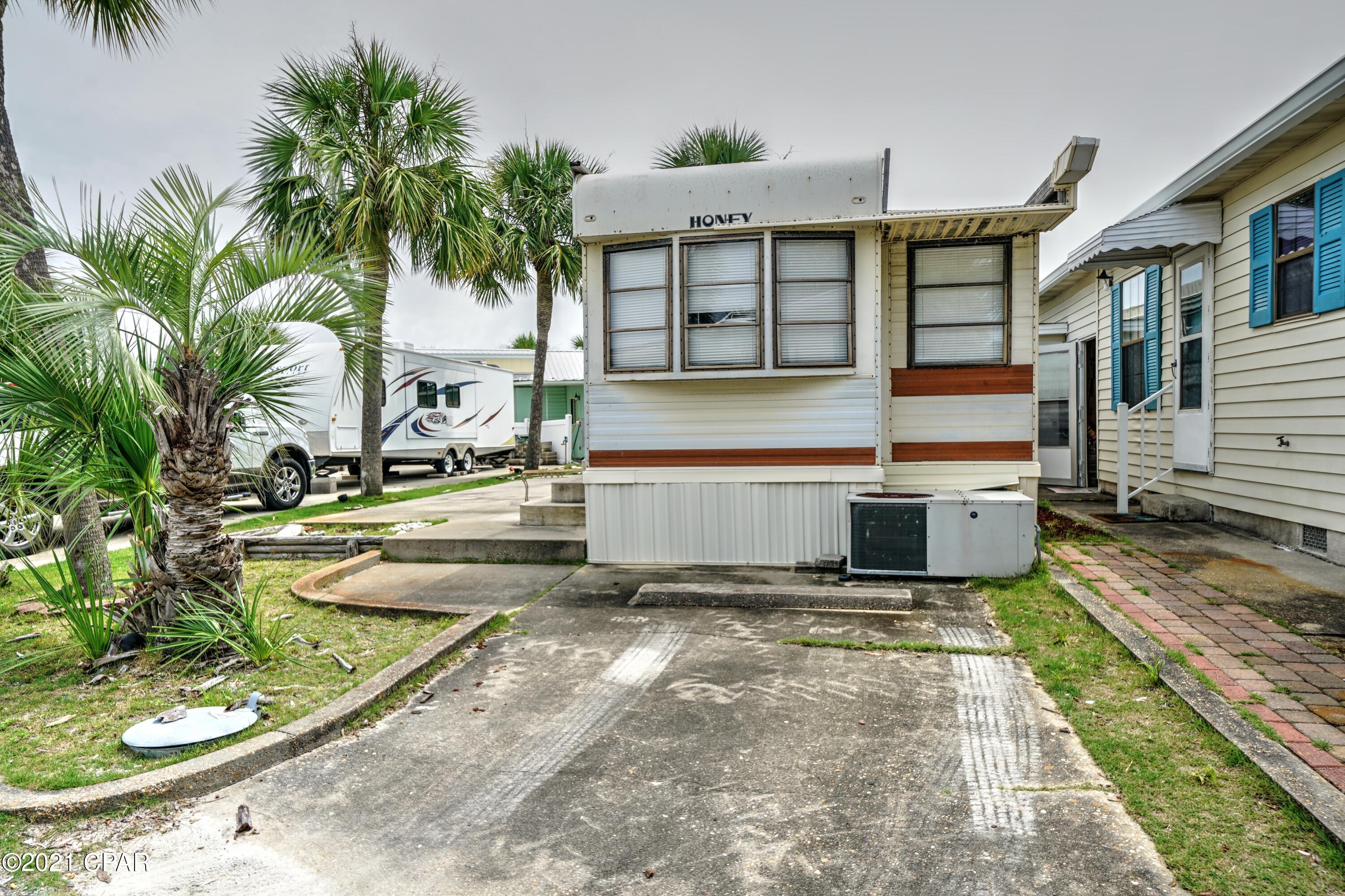 CURRENTLY UNDER CONTRACT, SELLER ACCEPTING BACKUP OFFERS Here it is... the lot you have been looking for in highly sought after Venture Out! Home has major hurricane damage, water damage, etc. and needs to be torn down/removed.  Fantastic location within the resort that is perfect for your new construction or use as an RV lot. Sold AS IS.  Venture Out is a golf cart community that has exploded with popularity recently... With 300' on the beautiful pristine beaches of the Gulf of Mexico and 1,000' on the Grand Lagoon. Venture Out has something for everyone. With 2 pools, fishing pier, boat ramp, mini golf, children's play ground and much much more!