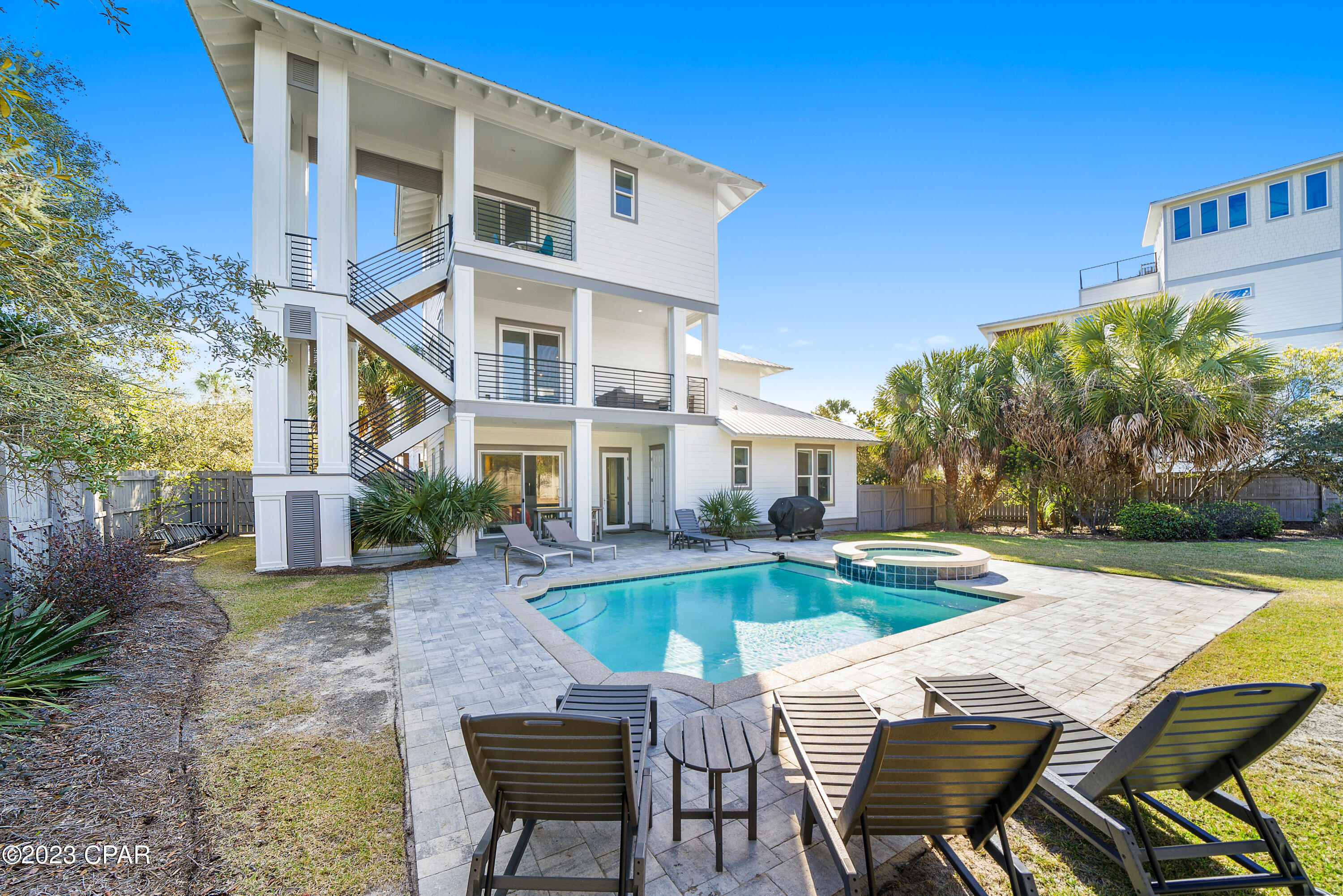 Located in highly touted Blue Mountain Beach, this contemporary beach house has superb gulf views right across the street from the white sandy beach. With over $200K in annual gross rentals this home is a powerhouse in Blue Mountain Beach. Completely renovated in 2022, it has ample room to expand in the oversized backyard. This peaceful private haven is in a quiet street and has its own heated pool, spa tub, outdoor shower and sprinkler system. There's even a surround sound system for listening to your own playlist while relaxing by the pool. Multiple balconies and private terraces abound on all three levels. They provide quiet nooks so that everyone can enjoy their own private space. Inside, this beautiful home has all the bells and whistles. The current owners have made their mark, reducing the garage in size and adding an extra bedroom and bathroom on the first floor. This additional guest bedroom and built-in bunk room make this the ideal rental vacation property for up 14 guests, or a main residence/second home for growing families. The home has a light bright interior with beautiful wood flooring and multiple oversize windows and doors. Stairs wind upwards to the second floor where the open living space is an irregular shape leading through the dining area to a well-appointed kitchen. There's a wine fridge for endless chilled beverages, a walk-in pantry and granite countertops. It's ideal for those who take food seriously with industrial-grade appliances making light work of snacks, family meals and entertaining. The breakfast bar supplements the formal dining table and there's access to the porch if you fancy dining outdoors. The entire third floor houses the master suite and boasts gentle sea breezes and expansive gulf views from the private balcony. A new roof, new exterior paintwork, dimmable lighting and a Rinnai water heater mean there's no to-do list when it comes to maintenance.