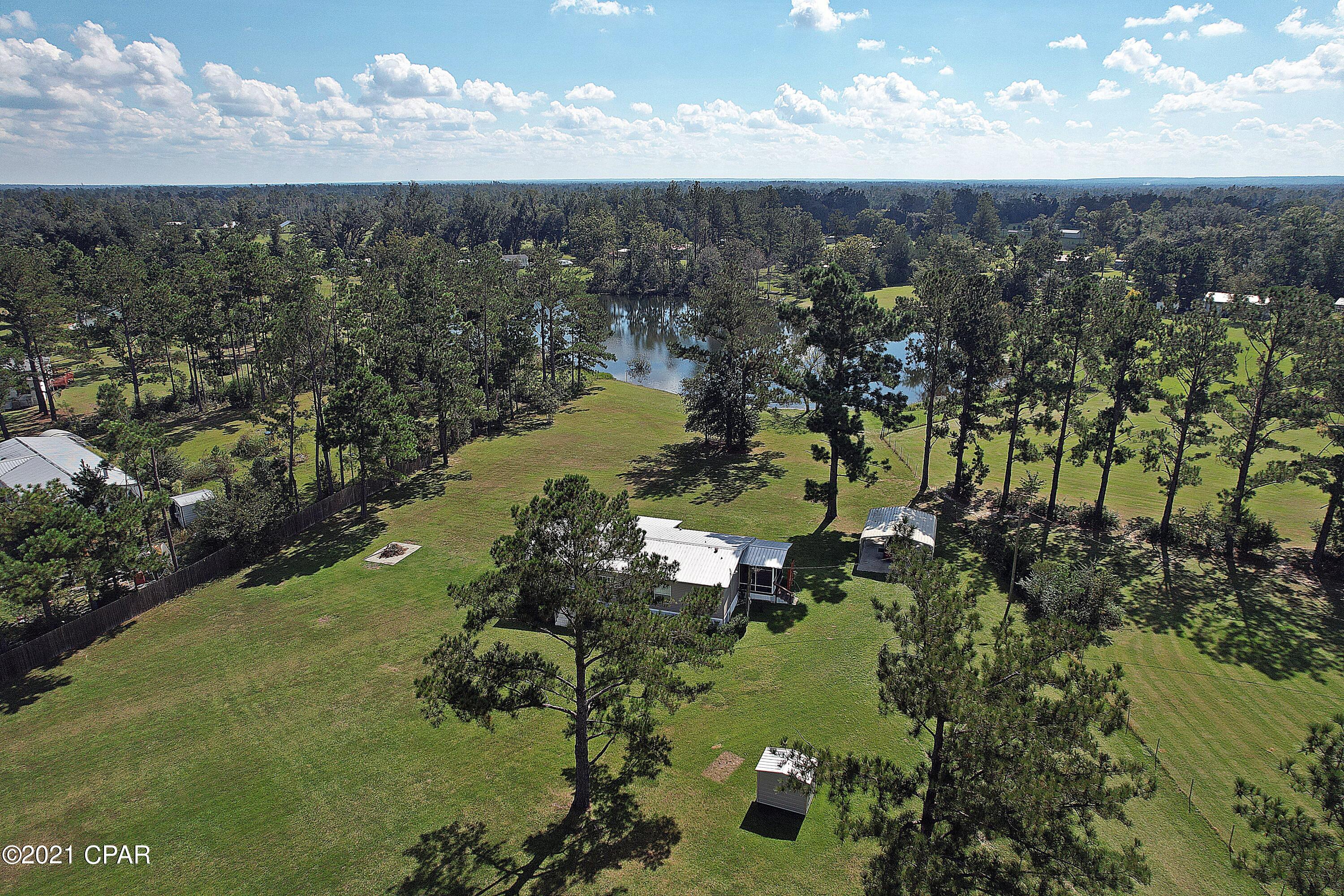 'CURRENTLY UNDER CONTRACT, SELLER ACCEPTING BACKUP OFFERS Very well-maintained home on over 2 ac and has over 100 ft of pond frontage. The appliances will stay with the home including the w/d. this open floor plan makes the home seem much larger, it also has an updated power pole, a metal roof, a 2-car carport, a side and back screened porch, large front yard and large back yard, the property is fenced as well and has a survey. Very easy to show.