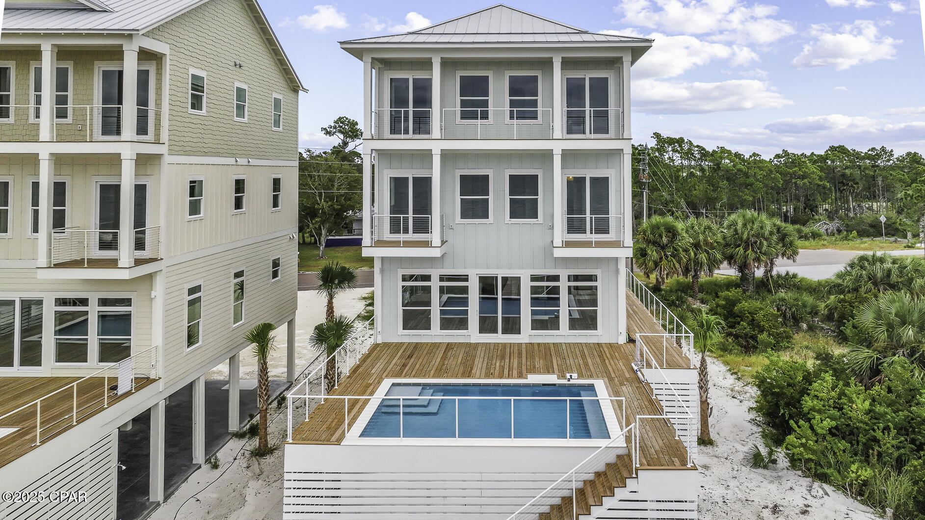CURRENTLY UNDER CONTRACT, SELLER WILL CONSIDER BACKUP OFFERS. ULTIMATE GULF FRONT HOME! Nestled on pristine Gulf front sand, 295 Watermark Way offers the ultimate coastal escape-where turquoise waves, sugar-white beaches & unforgettable sunsets set the stage for lifetime memories. This brand-new custom beachfront build, within the serene lower-density stretch of St. Joe Beach, effortlessly combines luxury, comfort & coastal charm. With six beautifully appointed suites, this home is perfect for multi-family vacations or large groups seeking space, style & shared experiences. Each beachfront king suite opens onto its own deck, allowing you to  awake to sea breezes and Gulf views. The homes best feature is a private heated pool just steps out the door to be enjoyed year round. The soaring open living spaces, gourmet kitchen & soft coastal finishes evoke easy elegance. The layout is designed for joyful mingling where you enjoy panoramic Gulf vistas from every level & wide decks that connect you to the horizon. An elevator provides smooth access across all floors. Beyond the walls of this spectacular home, you'll find immediate access to the Gulf with a private boardwalk & steps to powdery sand.   Hop in your golf cart or go for a peaceful bike ride along the paved paths to Windmark Beach where you will find fun, food, and entertainment for the whole family.   A short ride into Port St Joe connects you with  boutique shopping, fresh seafood restaurants, a bustling marina, and a charming historic district. Whether you're planning an epic family retreat, a generational reunion, or a carefree getaway with friends, this home is built to host in style. From sunrise yoga to cocktail hour on the deck, to late-night stargazing by the sea--every moment unfolds with elegance and ease. Call for your private tour & LIVE THE BEACH LIFE!