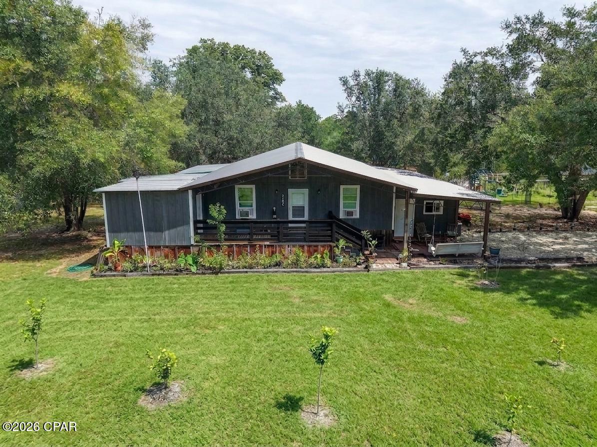 VERY MOTIVATED SELLER -- BRING ALL REASONABLE OFFERS!
Welcome to your own private retreat in the woods! Built in 2021, this unique barndominium is a nature lover's paradise, offering a peaceful setting with plenty of space for those who enjoy wildlife, gardening, hobbies, or simply relaxing away from it all.

With approximately 2,600 sq. ft. under roof, this thoughtfully designed property offers much more than just living space. A 12' x 20' attached additional dwelling unit, conveniently accessed from the front porch, provides flexible space for guests, extended family, a home office, hobby room, or private retreat. The ADU already has plumbing and electricity in place, including a sink and toilet, along with sheetrock, and is ready for the new owner to complete with their own finishing touches. Additional spaces include an 8' x 24' utility room and a 12' x 24' workshop, both under roof, giving you plenty of room for storage, projects, and equipment.

The home is filled with warm, rustic character, including beautiful pine floors and inviting covered porches with three separate levels, creating multiple areas to sit back, relax, and enjoy the surrounding woods and wildlife. Inside, you'll find newer appliances, a tankless water heater, washer and dryer, a beautiful walk-in tiled shower, and a relaxing soaking tub. The custom TV stand featuring a built-in electric fireplace and solid white oak top also conveys with the property.

The outdoor spaces are just as special. The yard features an assortment of established apple, blueberry, fig, pear, sassafras, and crepe myrtles, along with a 12' x 12' greenhouse and dedicated garden area with an automatic sprinkler system. An above-ground pool also conveys with the property, providing the perfect spot to cool off and enjoy some afternoon fun. Whether you enjoy growing your own fruits and vegetables, watching wildlife, swimming, or simply spending time outdoors, this property was made for enjoying nature.

Conveniently located near Highway 231 and only approximately 40 miles from Panama City, you can enjoy the privacy and tranquility of country living while still being within an easy drive of shopping, dining, entertainment, and the Gulf Coast.