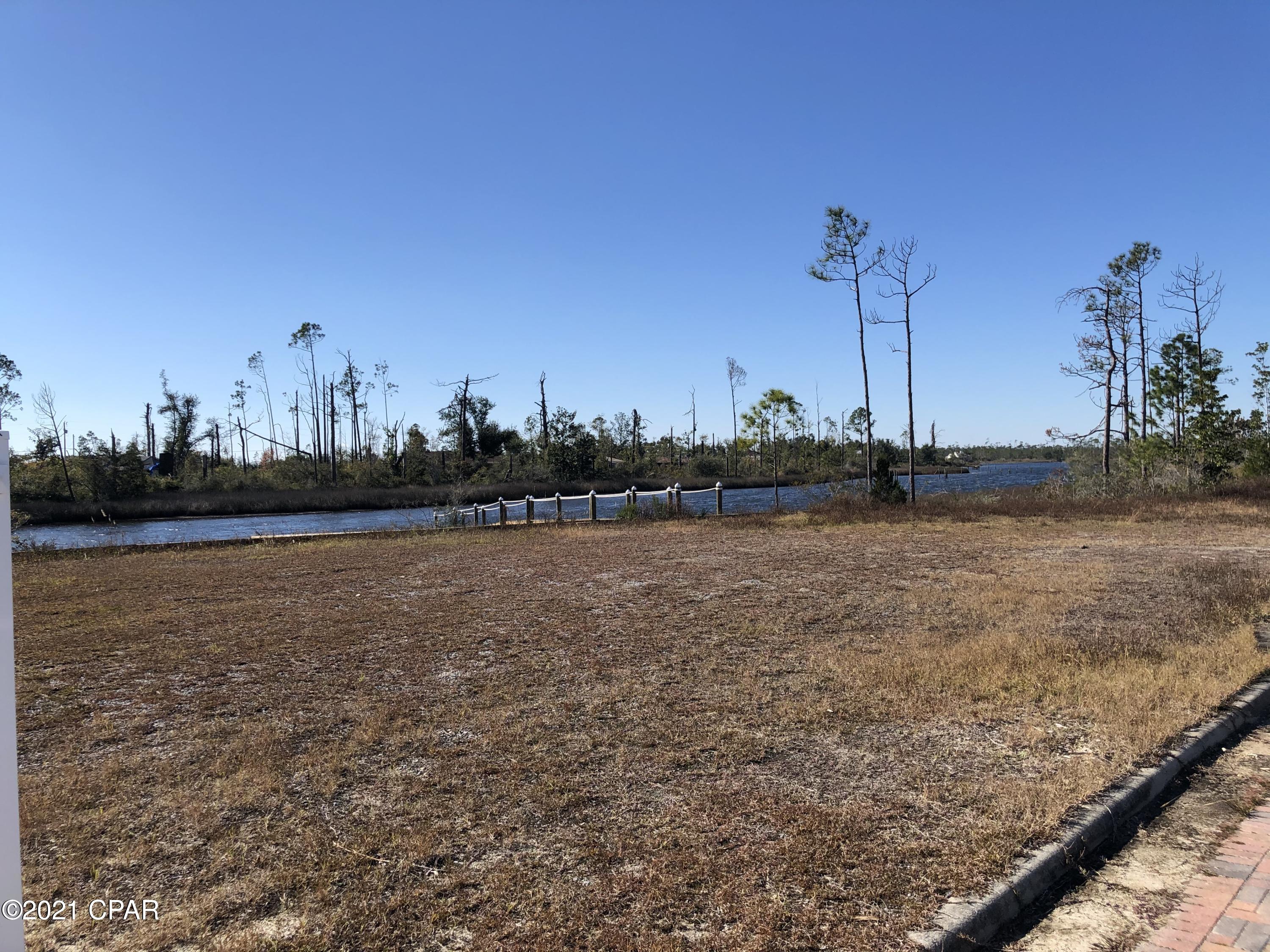 Subject offering consists of 139 developed lots with all infrastructure in place. On public water an sewer, the impact fees of $5,502 per lot are paid bringing the asking price to just $17,500/lot.  A part of the East Bay plat with 321 total lots, it is located on Cook's Bayou with deepwater access to St. Andrew's Bay, the Intracoastal Waterway and the Gulf of Mexico and just 10 minutes from Super Walmart, 20 minutes from Tyndall Air Force Base.  The existing roads in Phase I have been turned over to the City of Callaway for maintenance. This should allow for lower HOA fees. The roads have brick paver accents through out the project. Available separately, the +/- 6 acre marina site has over 650 FF on Cook's Bayou with dredgable deepwater near the shoreline. It has been cleared and comes wi over 650 FF on Cook's Bayou with dredgable deepwater near the shoreline. It has been cleared and comes with a 3,300 Sq. Ft. Club House and dock built in 2020. Near the marina site is a 2.72 acre site for RV/Boat storage. The 189 unfinished lots also have had their impact fees paid, again at $5,502 per lot.  The City of Callaway is primed for growth over the next few years with Eastern Shipbuilding getting the largest Coast Guard Cutter building contract in Coast Guard history and an expanded missions for Tyndall AFB. The Gulf Coast Parkway will run just East of the subject property. This will be a Hwy 98 re-route to bypass Tyndall AFB.