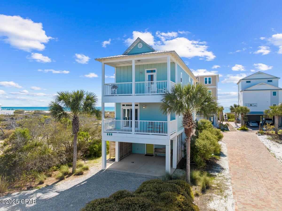 SEASIDE LUXURY FOUND! Discover the perfect blend of coastal charm, modern comfort & investment potential - 122 Summer House Ln. Just steps from the sugar-white sands of the Gulf, this inviting 3 bedroom/3.5 bathroom retreat offers everything needed to embrace the laid-back lifestyle of Florida's Forgotten Coast. The thoughtfully designed floor plan features open-concept living, dining & kitchen areas that flow seamlessly together, creating an ideal space for entertaining family & friends. The well-equipped kitchen is ready for everything from casual beach breakfasts to evening gatherings, while multiple decks & balconies provide the perfect setting to enjoy Gulf breezes, morning coffee, coastal views & spectacular sunsets. Spacious bedrooms offer privacy & comfort for owners & guests alike, including a relaxing primary suite complete with its own private bath. An outdoor shower makes rinsing off sandy toes effortless, while the elevator servicing all levels adds convenience & accessibility. Step outside & enjoy deeded beach access just moments from your door. When you're ready for a break from the surf, the community pool is only steps away, offering a refreshing place to cool off & relax. Outdoor enthusiasts will appreciate direct access to the Loggerhead Bike Path, an 8-mile paved trail connecting St. Joseph Peninsula State Park to Salinas Park, perfect for biking, jogging, wildlife viewing & sunset strolls. Just a short drive away, Port St. Joe offers fresh local seafood, boutique shopping, marina activities & small-town coastal charm. With a proven history as a successful short-term rental, this property presents an exceptional opportunity as a personal beach retreat, income-producing investment, or the perfect combination of both. Experience the tranquility, natural beauty & unforgettable lifestyle that make Cape San Blas one of Florida's most treasured coastal destinations. Call for your private tour & LIVE THE BEACH LIFE!