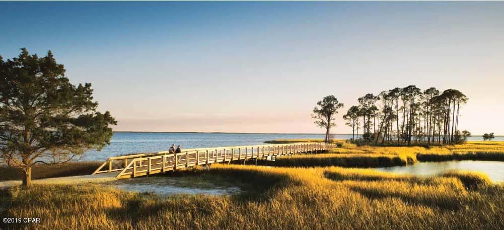 Rivercamps on Crooked Creek is the most unique neighborhood in  Panama  City Beach!  A true hidden gem! This wonderful community is nestled between Crooked Creek,  Westbay, and the intercostal waterway. It is close to everything....restaurant,  Pier Park,  The World Most Beautiful Beaches,  and the ECP.  This St Joe planned community also offers unparalleled amenities....walking trails, pool, table tennis, basketball,  kayaks, boat launch, boat storage, library,   bikes,  and more... This is a large, 1.35  acres beautiful pond frontage lot ready to build your dream home in this exceptional neighborhood! This lot allows the option to build on grade, as a large portion of the property is in flood zone X.