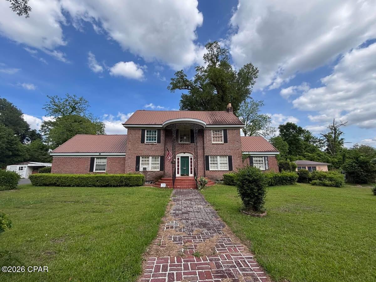 INVESTORS SPECIAL! This unique Colonial-style brick home, built in 1938, offers approximately 3,700 heated and cooled square feet filled with timeless character and endless potential. Featuring 4 bedrooms 3.5 bathrooms and 4 fireplaces, this spacious home is ready for restoration and would make an incredible primary residence, investment property, or Airbnb opportunity.

Step inside to find a stunning wooden staircase, beautiful hardwood floors, and classic architectural details throughout. The formal living room features hardwood floors, a fireplace and opens into what was once used as a charming music room, creating an elegant space for entertaining or relaxing. The formal dining room includes a butler's pantry leading into the kitchen, which features solid surface countertops, modern appliances, and opens to a generous family room perfect for gatherings.

The oversized downstairs master suite offers multiple closets along with his-and-her vanities in the private bath. Upstairs, you'll find 3 additional bedrooms with hardwood floors and 2 full bathrooms providing plenty of space for family or guests.

The huge basement includes another fireplace and laundry area and could easily be transformed into a game room, recreation space, workshop, or additional living area.

Situated on a large lot in a desirable area of Marianna, FL, this property is conveniently located near the hospital, medical offices, restaurants, shopping, and other amenities. This historic gem is just waiting for someone to bring it back to life!

Don't miss this rare opportunity to own a one-of-a-kind property with character, space, and incredible investment potential. Measurements are approximate, verify if important.