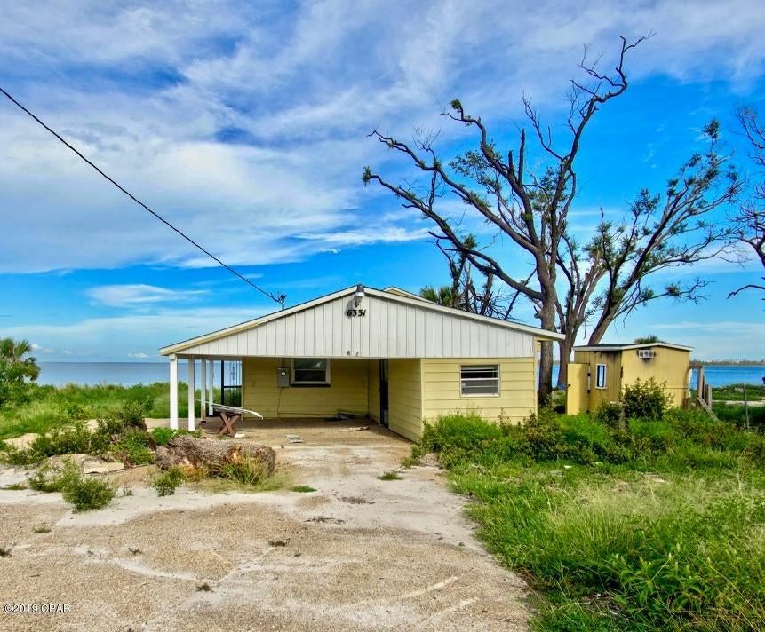 Great opportunity to own over 1 acre of Bay Front property. This one of a kind property is conveniently located to Tyndall Air Force Base, shopping and dining. Spend the day relaxing on your own private beach overlooking the breathtaking views of the Bay. This home boast over 1,300 sq.ft with 2 bedrooms and a carport. A new roof was recently installed and the interior is ready for you to come in and make it your own. Whether you like boating, fishing, or you're looking for a great investment don't hesitate to schedule your showing today!