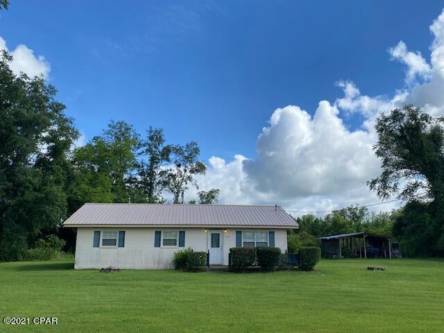 3 bedroom, 2 bath home on a paved road in the country!  This is a concrete block home with a new roof, new HVAC and new well.  With a little TLC, this inside can be a cute home!  There's a small carport to park your boat & lawn mower under.  Call today to see this home!