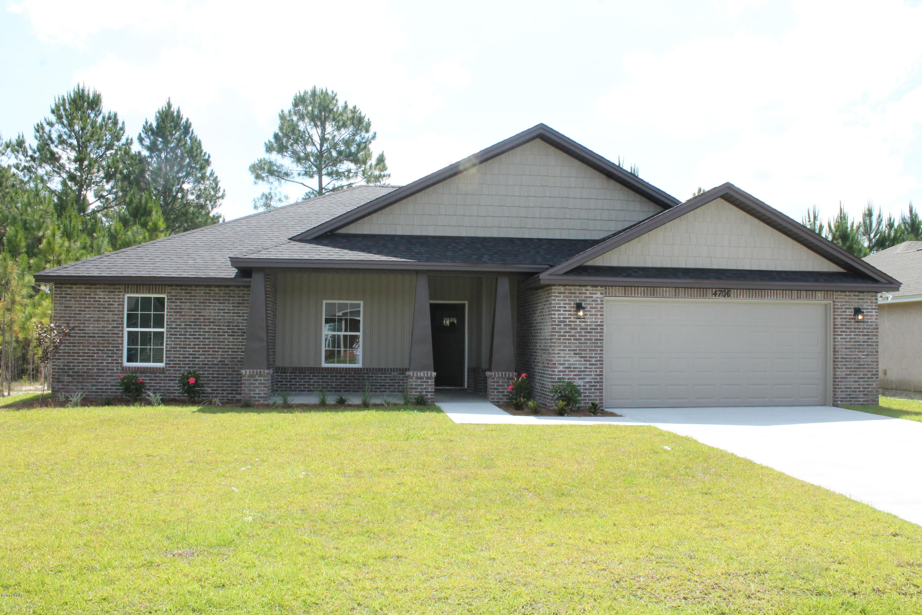 LOVELY CRAFTSMAN STYLE HOME conveniently located to Tyndall AFB. Very Open Split Bedroom Plan, 4 bedrooms, 2 baths.  The kitchen, dining and family rooms are open with the master suite on one side and the other 3 bedrooms and bath on the opposite side of the home. The home will have dark stained shaker style cabinets with a dark grey kitchen island, granite tops, upgraded plumbing fixtures, lovely light colored grey toned walls with painted ceilings, crown molding, wood style tile throughout the main living area and walk ways, travertine style tile in bathrooms and Mohawk carpeting in the bedrooms. The 2 car garage has pull down stairs for attic access. Inviting Covered Front Porch and Covered Back Patio. Great Neighborhood! Almost Complete! Make your showing appointment today!!!