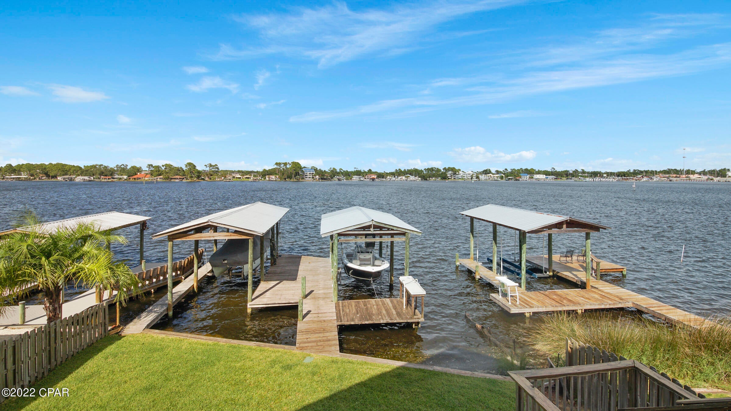 $40,000 PRICE REDUCTION!!  ENJOY A GORGEOUS MILLION DOLLAR VIEW CONDO (with only two units) from your 10x30 deck on South Lagoon! Private and relaxing with your own dock, 5000# boat lift, boat house, kayak, and a fish cleaning station. Enjoy the sunrise and watch the dolphins. Great vacation home and never rented. Open floor plan with large living/dining area with long breakfast bar, granite countertops, crown molding, tile and vinyl plank flooring. South lagoon is convenient to shopping, restaurants and approximately 1/4 mile to the beautiful white beach. Room sizes are approximate. Please measure if important.