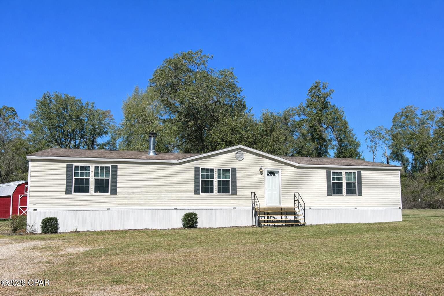 * All Offers Welcomed! Tucked away at the end of a gated driveway and surrounded by farmland and wooded acreage, this 3-bedroom, 2-bath mobile home on 2 private acres offers the kind of peace and privacy that's hard to find. The mostly fenced and cleared yard provides plenty of room to roam, garden, or simply enjoy the quiet, with woods on all sides creating a true retreat from the hustle and bustle.

Inside, the home features a split floor plan with an open-concept living area, perfect for everyday living and entertaining. All bedrooms include large walk-in closets, and one of the guest bedrooms is nearly the size of the primary suite, offering flexibility for a second living space, home office, or oversized guest room.

The primary suite features a beautiful soaking tub, creating a relaxing space to unwind. Step outside to the large back porch, ideal for morning coffee, evening sunsets, or taking in the surrounding nature.

This property is designed for self-sufficient living, as the entire home can operate on the included backup generator, providing peace of mind and reliability year-round. Additional features include a shed with a loft in great condition for storage or workspace.

Even better, a riding zero-turn lawn mower, all appliances, washer and dryer, and an extra fridge/freezer combo all convey with the property--making this a truly turn-key country retreat.

If you're searching for complete privacy, quiet surroundings, and a home ready for independent living, this one checks every box. 🌿🏡
***With a full price offer, all furniture will be included.