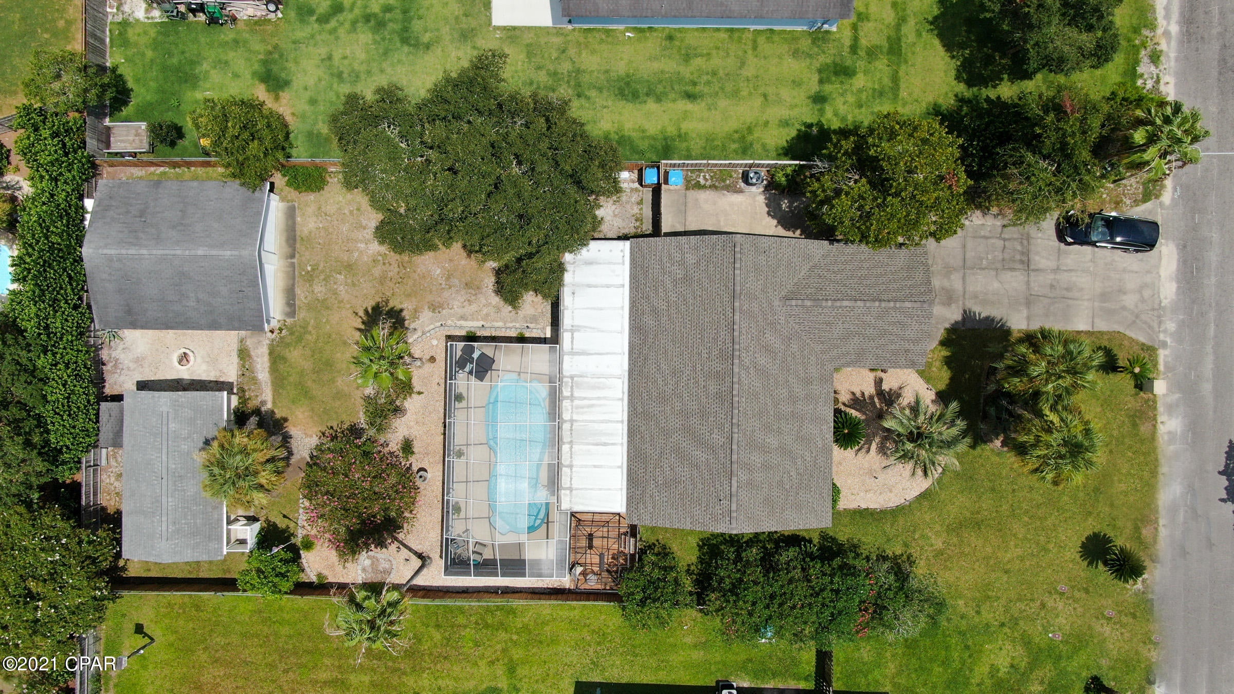 CURRENTLY UNDER CONTRACT, SELLER ACCEPTING BACKUP OFFERS. Ready to live at the beach or looking for a perfect second home? This lovely property is on an oversized lot with an in-ground pool on the desirable west end of PCB! Unfortunately NO SHORT TERM RENTALS ALLOWED in subdivision of Gulf Vista. This home will not disappoint, with a new roof and new A/C as of Jun/Jul 2021 and a new water heater as of Aug 2021. Enjoy the tropical landscaping, attached garage, 3 bedrooms, 2 full bathrooms, open floor plan living/dining space, and enclosed back porch.  Relax on the expanded covered patio next to the pool with screened enclosure!  Additional 336 sqft heated/cooled cottage adds a great feature! The back yard is fenced with a gate at driveway leading to a detached two-car garage! This home is located in a quiet, golf cart friendly neighborhood that is close to the beach and so much more! This is the second owner of this home and they have taken great care of the property with many updates over the years. Enjoy tile flooring throughout the home and plenty of closets/storage space. The kitchen has stainless steel appliances with a breakfast bar, and is waiting for the next owner's personal touches! This property has mini-split heating and cooling features in the enclosed back porch and guest house. Outside you'll also find an outdoor shower, firepit, and additional outdoor storage tucked behind the garage and guest house. This property has so much to offer and would be great for entertaining! Plenty of parking and garage spaces for your cars, boats, and more!