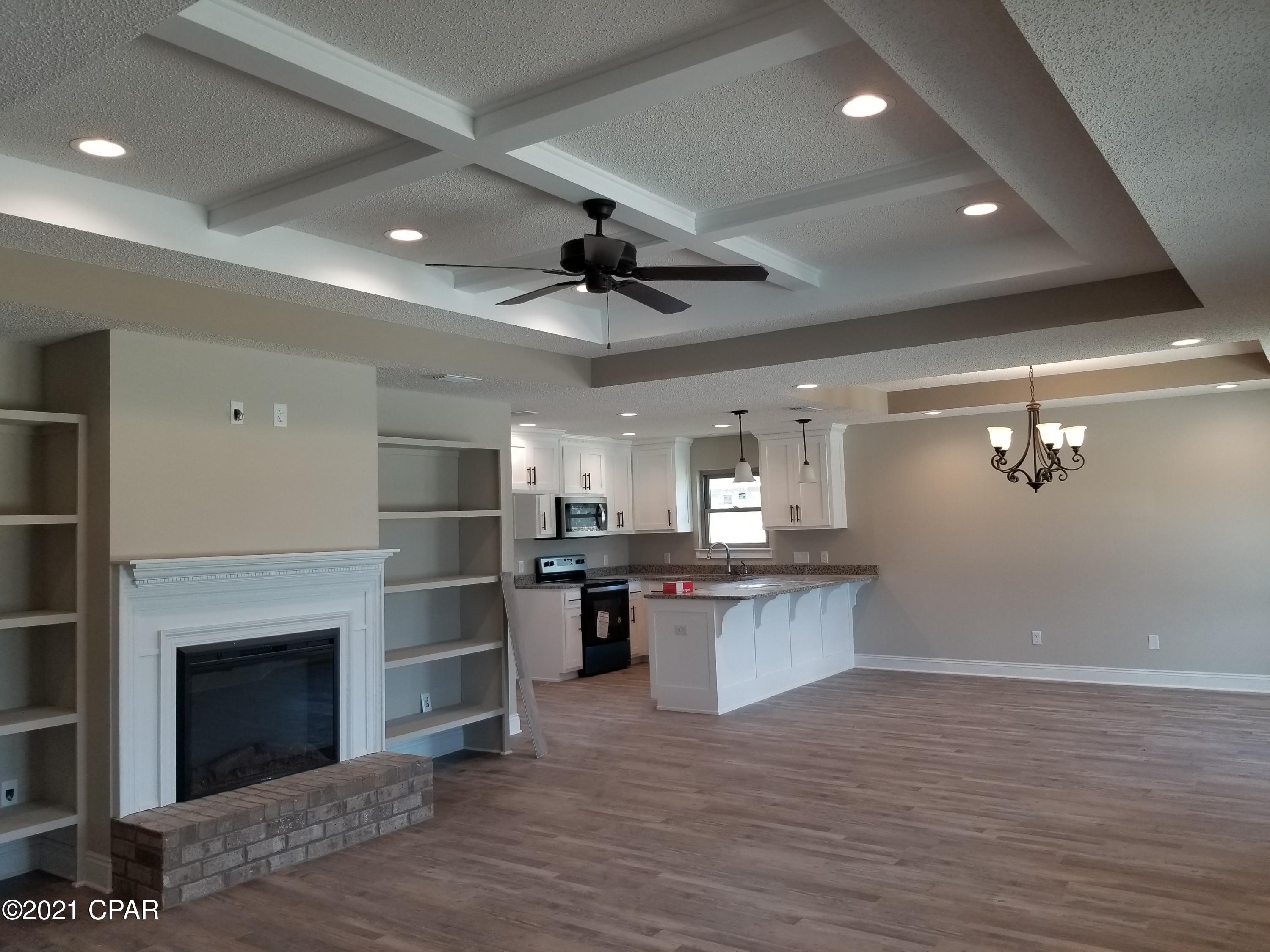 Brand New Move-In Ready close to everything! 3 bedroom 2 bath 2 car garage with built-in tool cave all brick home that offers Master bath with his & hers double shower with Rain maker (3 shower heads) and shower seats on both ends. Master bedroom has rope lighting, large walk-in closet. The kitchen is a dream with all real wood cabinets, Granite countertops and stainless steel upgraded appliances. There are cabinets in the laundry room. Living room with and electric fire place and crown molding with lots of recessed lighting and a Florida room. Home comes with thermoseal spry foam system, security system and generator ready electrical outlet with cord. Outdoors Is a front porch and back open patio, outside shower and sprinkler system.