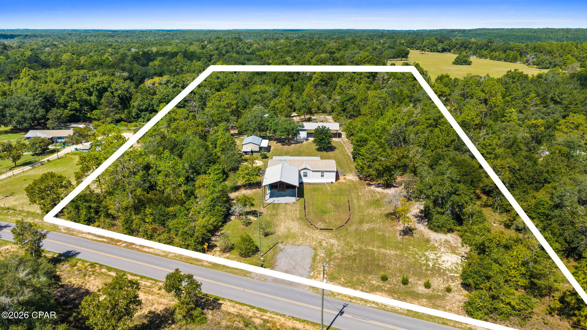 Escape to the country and enjoy the peace, privacy and open space that surrounds this home and the 5 acres of land it sits on.  This home is perfect for those looking for a quiet rural lifestyle with plenty of room to spread out.  The back porch is perfect for entertaining or just enjoying your morning coffee.  There is a workshop and two pole barns that have more than enough room for storage.  There is plenty of space for gardening, outdoor activities, having animals or simply relaxing in the tranquility of country living.   Parcel numbers 00000000-00-3327-0012 and 00000000-00-3327-0024 are included in this sale.