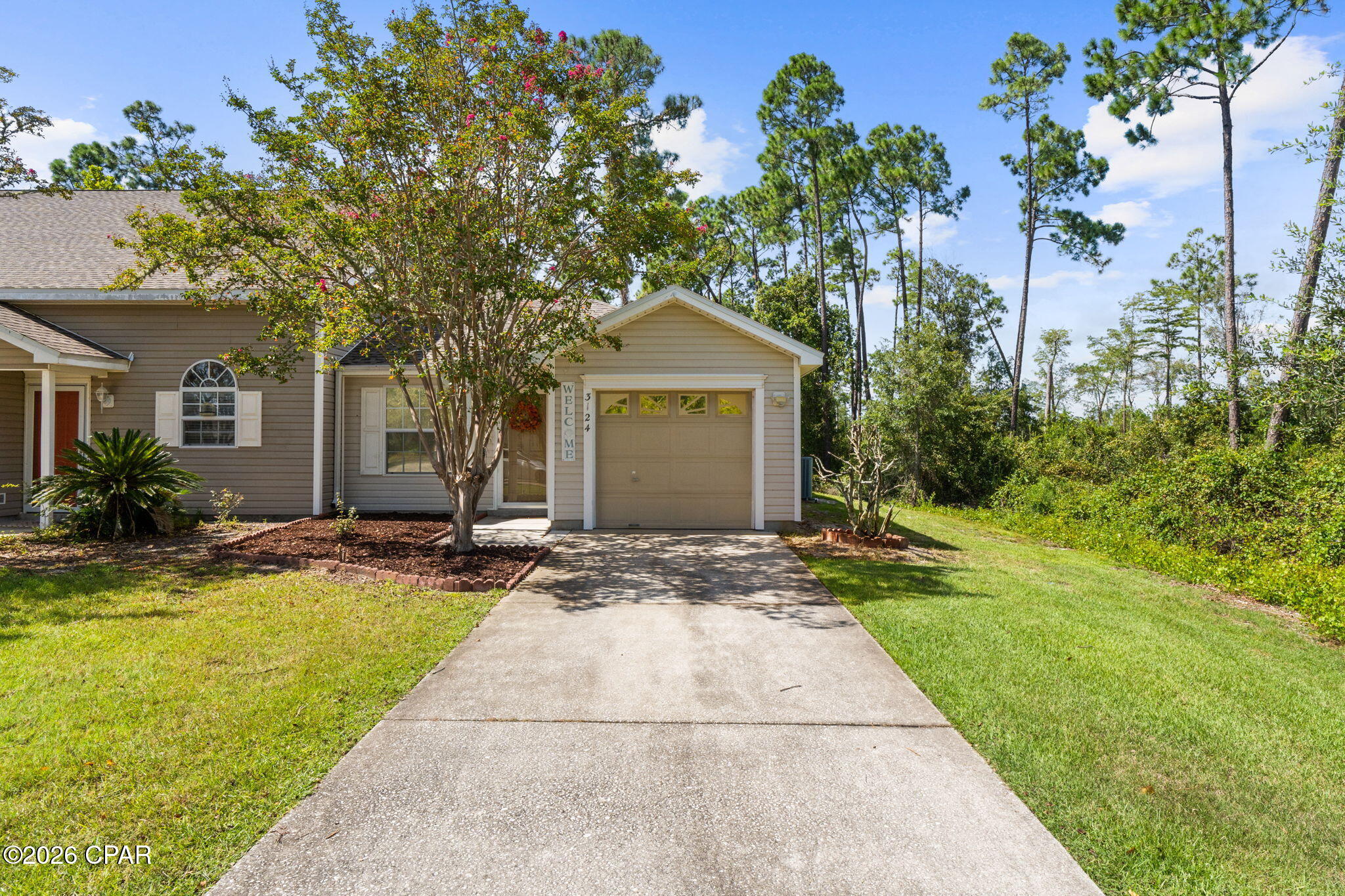 Welcome to 3124 Downy Branch Lane, a comfortable and low-maintenance Lynn Haven home offering a convenient location close to schools, shopping, dining and everyday necessities. Whether you're purchasing your first home, looking to downsize or simply want an easy-to-manage property, this home offers a practical layout with plenty to appreciate.

Inside, the open living and dining area flows into a spacious kitchen featuring abundant white cabinetry, generous counter space, a breakfast bar and plenty of room for everyday cooking and entertaining. LVP flooring runs through the main living areas, while the bedrooms offer comfortable spaces with great natural light. The primary suite includes a private bath with a tiled walk-in shower and built-in bench.

One of the home's standout features is the screened-in back porch, creating a great spot for morning coffee, relaxing in the evenings or enjoying the outdoors without leaving the comfort of home. The property also offers an attached one-car garage, manageable yard space and a wooded backdrop that provides a little extra privacy.

Conveniently located in Lynn Haven with quick access to schools, grocery stores, restaurants, shopping and major roadways, 3124 Downy Branch Lane offers an easy lifestyle in a location that keeps you close to everything you need!