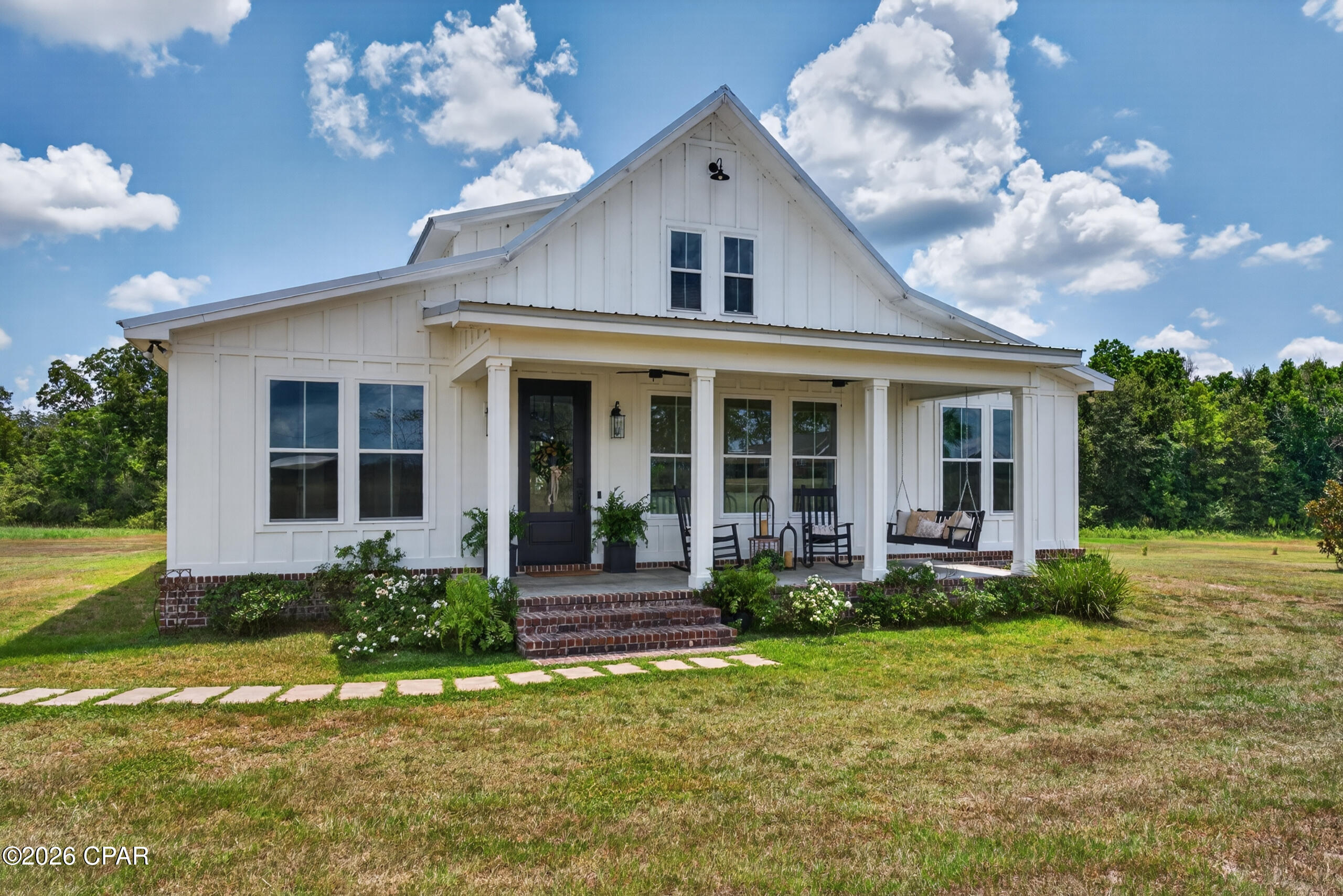 Set on 3.09 peaceful acres, this beautifully crafted 2022 farmhouse pairs timeless Southern style with elevated finishes and thoughtful construction. From the moment you step inside, the home feels open, airy, and effortlessly inviting, with dramatic 19-foot ceilings and expansive 6-foot windows that bathe the main living space in natural light. Nine-foot ceilings throughout the remainder of the home continue the sense of spaciousness, while 2x6 exterior walls, spray foam insulation, and a 50-year metal roof speak to the quality behind the beauty.

At the heart of the home, the chef-inspired kitchen is both striking and functional, featuring GE Café appliances, double ovens, crisp white shaker cabinetry, a farmhouse sink, pot filler, and generous walk-in pantry. The open-concept design allows the kitchen, dining, and living spaces to flow seamlessly together, creating an ideal setting for everything from quiet mornings at home to lively gatherings with family and friends.

A thoughtfully designed split-bedroom floor plan offers privacy, while the primary suite provides a serene retreat. The ensuite bath is beautifully finished with dual vanities and a tiled walk-in shower, creating a space that feels polished yet comfortable.

Outside, the home gives way to a true backyard retreat. The gunite chlorine pool anchors an inviting outdoor oasis made for long summer afternoons, evening gatherings, and relaxed weekends at home. Beyond the pool, the 24x24 barn with two 12-foot lean-tos with concrete and electric adds both character and versatility, offering ample room for storage, equipment, hobbies, or recreational use.

With its combination of gracious proportions, quality craftsmanship, modern farmhouse details, and a setting that feels both private and welcoming, this is a home designed to be enjoyed just as much as it is admired.