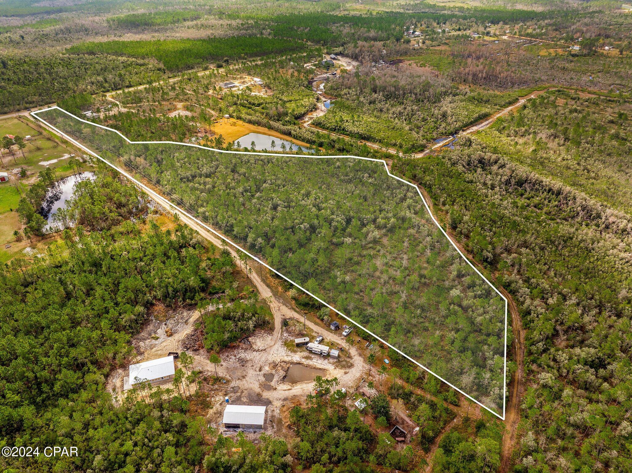 Here is your chance to own your own piece of paradise with room for privacy.  10+ acres on Hwy 388 is perfect for a Barndominium  or similar style with space between neighbors, room for horses, or all of the above.  Picture turning off of the main road to a long driveway with the house sitting back away from the road noise and build your peaceful escape called home.  This property is just quick drive to Northwest Florida Beaches International Airport, Econfina water management area, multiple natural springs, etc when you need to get away or relax on a hot summer day.   Bay county is growing north and will soon have more options for groceries and dining in this area.  This is your opportunity to get ahead of the growth and secure a spacious homestead before they get sold.  Contact your favorite Real Estate Agent today!