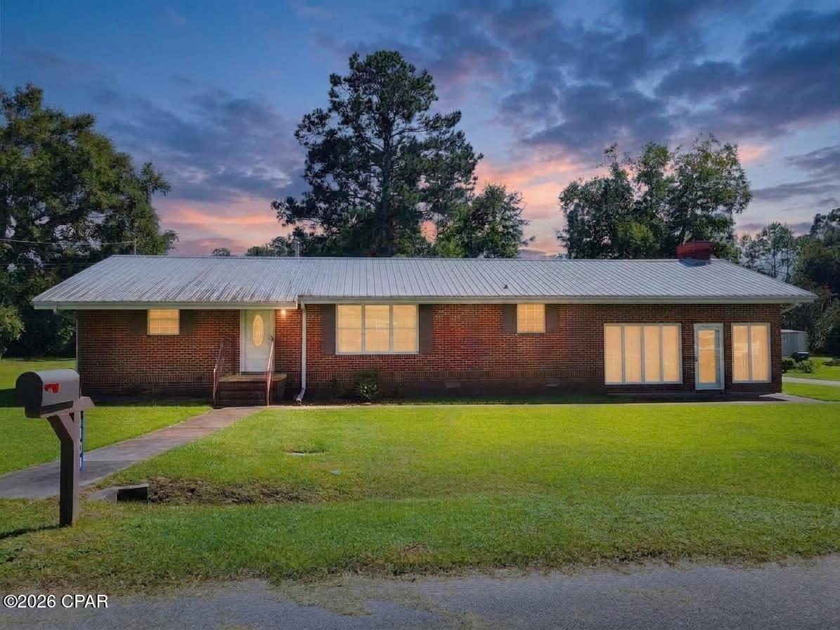 Welcome to this spacious 3-bedroom, 3-bath brick home situated on a beautiful half-acre lot in Graceville, just minutes from The Baptist University of Florida. With generous living spaces, a flexible floor plan, and handicap-accessible features, this home has plenty to offer!

Step inside to a large 20' x 17' living room featuring impressive 10-foot ceilings and a cozy wood-burning fireplace. An adjacent office provides a great space for working from home and includes its own bathroom, including the primary suite, with a large laundry room conveniently located nearby.

A few steps up lead into the kitchen and dining area, where French doors open to the back porch and carport area, making it easy to enjoy the spacious backyard. The home also features a large formal living room, providing even more room for entertaining, relaxing, or creating a space that fits your needs.

Two of the bedrooms have convenient access to their own bathrooms, including the primary suite, which features a beautiful tiled shower designed with handicap accessibility in mind, and flooring throughout the home includes a mixture of carpet, ceramic tile, and wood-look tile. Additional features include a durable metal roof, a 2022 HVAC system, and city water and sewer.

Outside, the beautiful half-acre yard offers plenty of room to enjoy the outdoors while still being conveniently located near the heart of Graceville. With its solid brick construction, spacious layout, accessibility features, and convenient location near the college, this home is ready for its next owner!