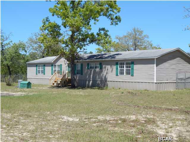 Every once in awhile a home comes along that MUST be seen to BELIEVE. If you are looking for a home that looks, feels, & smells NEW, look no further. This home sits on 7.5 acres in one of the most peaceful areas of Bay County. It comes with 3 storage facilities and two chain kennels. It has new custom built entry stairs in front and back.You really must see this home to appreciate how ''move-in'' ready it is. With an extra large walk-in closet in the master bedroom,there is plenty of room for your belongings. Listen to your favorite music as the built in stereo plays throughout the home. Or, catch up with your facebook friends as you sit at the awesome work station. Do you like to cook ? The kitchen is designed to accommodate several cooks at one time. There are too many extras to
