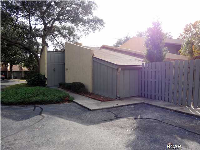 Nice End Unit Townhome with Private Courtyard in the Desirable Community of Delwood Estates. Central to Panama City and within reach to Panama City Beach, Tyndall AFB and Lynn Haven. Freshly painted inside and outside this unit features 8 Ft ceilings, spacious living room and dining area, Kitchen has a breakfast bar with overhead lighting, a large walk-in closet in master bedroom, a storage organizer with shelving in both guest bedroom closets, bamboo and laminate flooring in all the bedrooms and in the dining room, tasteful vinyl flooring in All the common areas and both bathroom with shoe floor molding. The exterior features Private Courtyard with Lush Tropical plants and Palm Trees. Also in the back yard is a storage building. All this among mature oaks and beautiful landscaping