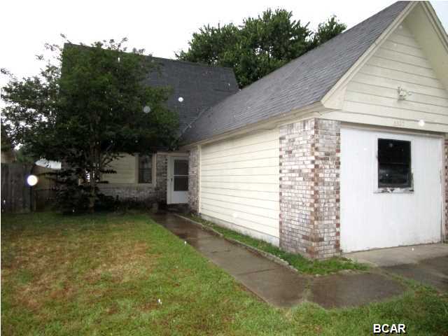 IF YOU NEED A LITTLE SPACE, THIS COULD BE THE ONE! This home has a great floor plan with a galley-style kitchen, adjoining dining area, a large living room that opens to a screened porch, and a Master bedroom and bath all on the first floor. Also, the garage has been converted to a fourth bedroom with its own wall a/c unit. The second floor features a loft area at the top of the staircase that is perfect for a computer area or small office. There are two additional bedrooms on the second floor with a full bath. This neighborhood is within a short drive to Tyndall AFB and walking distance to the Super Wal-Mart! With a little work and vision, this could be a great home! Home is being sold in its AS IS condition.
