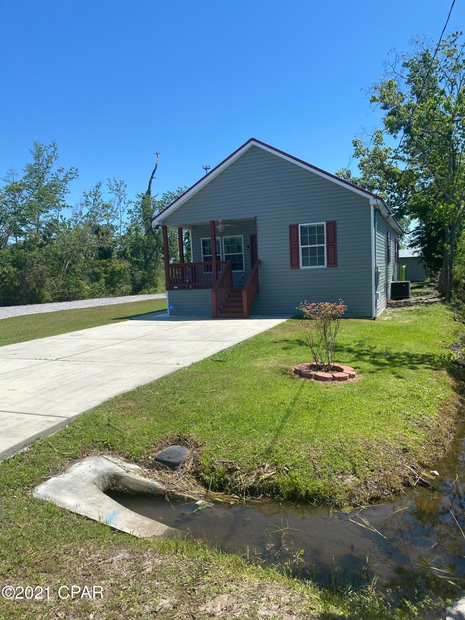 320 N Mary Ella Avenue, Panama City, FL 32404 is a 3 br 2 ba house located on almost 1/2 an acre near Callaway Elementary. Close proximity to the base and city living. As you walk in the home you'll notice it has a country cottage/farmhouse feeling with the vinyl flooring throughout and upgraded cabinetry with soft close features. The split floor plan has the guest bathroom and 2 bedrooms at the front of the house and the master is off the kitchen towards the back. A workshop/detached garage is the second driveway/access and has electrical/power to it. Spray foam on the interior creates a weather controlled environment for vehicles or workshop items. Please schedule your viewing today!