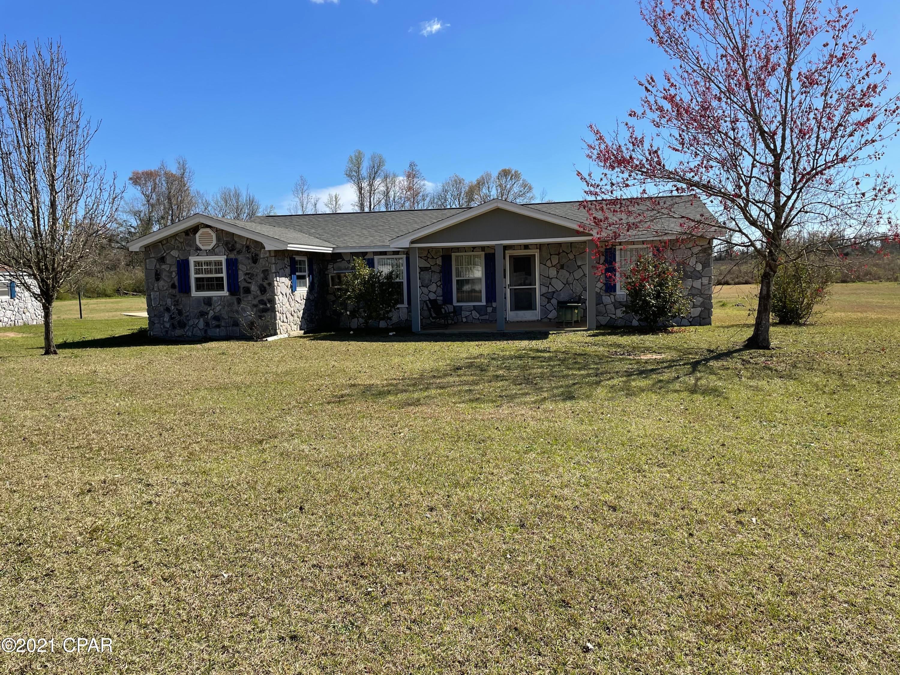 Nice country home on 3 acres with a pond!  This 2/2 home has 2100 sq. ft. of open living.  All of the rooms are large.  Home comes with a nice wood burning stove, along with central air/heat.  Listing includes a detached 2-car garage, an unfinished apartment with kitchen and plumbing for bath and a workshop attached to the garage.  The property has a place for an above ground pool.  Close to I-10 and Hwy 231.  This property will not last long!