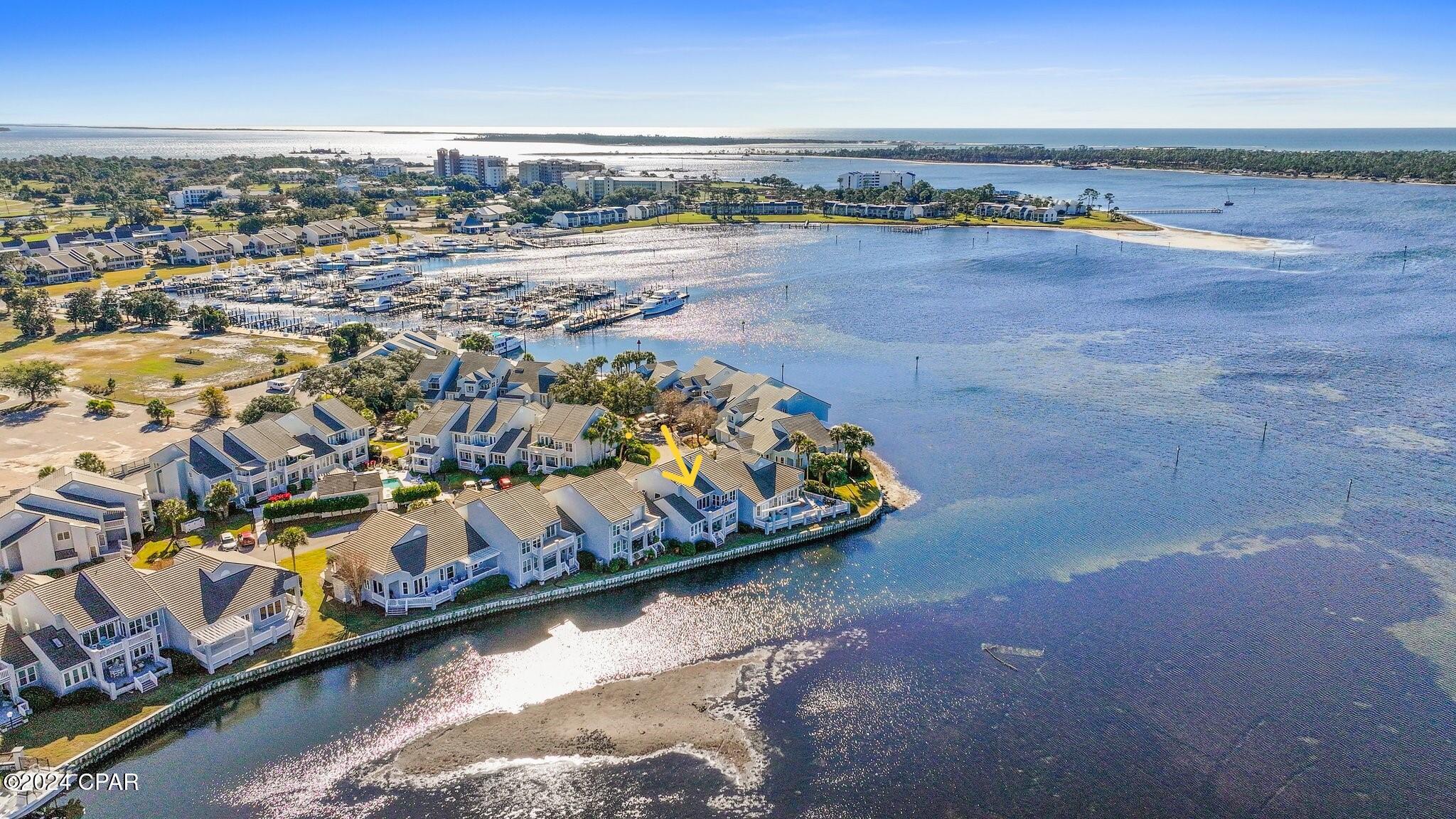 CURRENTLY UNDER CONTRACT, SELLER WILL CONSIDER BACKUP OFFERS'>>>>$100K PRICE REDUCTION>>>  SELLER SAID LET IT GO>>>>> WATERFRONT LIVING WITH STUNNING SUNSET VIEWS...
     Experience the best of coastal living in this beautifully maintained 2-bedroom, 2-bath waterfront condo located in the desirable Marina Club Village at Bay Point. Situated on the first floor with convenient single-level living, this immaculate residence offers 1,486 square feet of comfortable space with breathtaking sunset views from nearly every room, including the living room, dining area, kitchen, and primary bedroom.
     The thoughtfully designed interior features granite countertops in the kitchen and both bathrooms, stainless steel appliances, and a spacious eat-in kitchen with breakfast bar, perfect for casual dining or entertaining. A separate dining area flows seamlessly into the living room, highlighted by a charming corner electric fireplace connection that adds warmth and character.
     Throughout the home you'll find low-maintenance tile and luxury vinyl plank flooring--no carpet--making beach living effortless and easy to maintain. The bedrooms are generously sized, larger than many typical beach condos, providing comfort and flexibility for owners and guests alike. Custom shutters on all windows and the front door add an elegant finishing touch.
     Enjoy tranquil waterfront surroundings, marina access, and the relaxed lifestyle that Bay Point is known for--all just minutes from the beaches, dining, golf, and entertainment of Panama City Beach.
     Whether you're searching for a primary residence, vacation getaway, or investment property, this stunning waterfront condo offers an exceptional opportunity to enjoy the best of Florida coastal living.