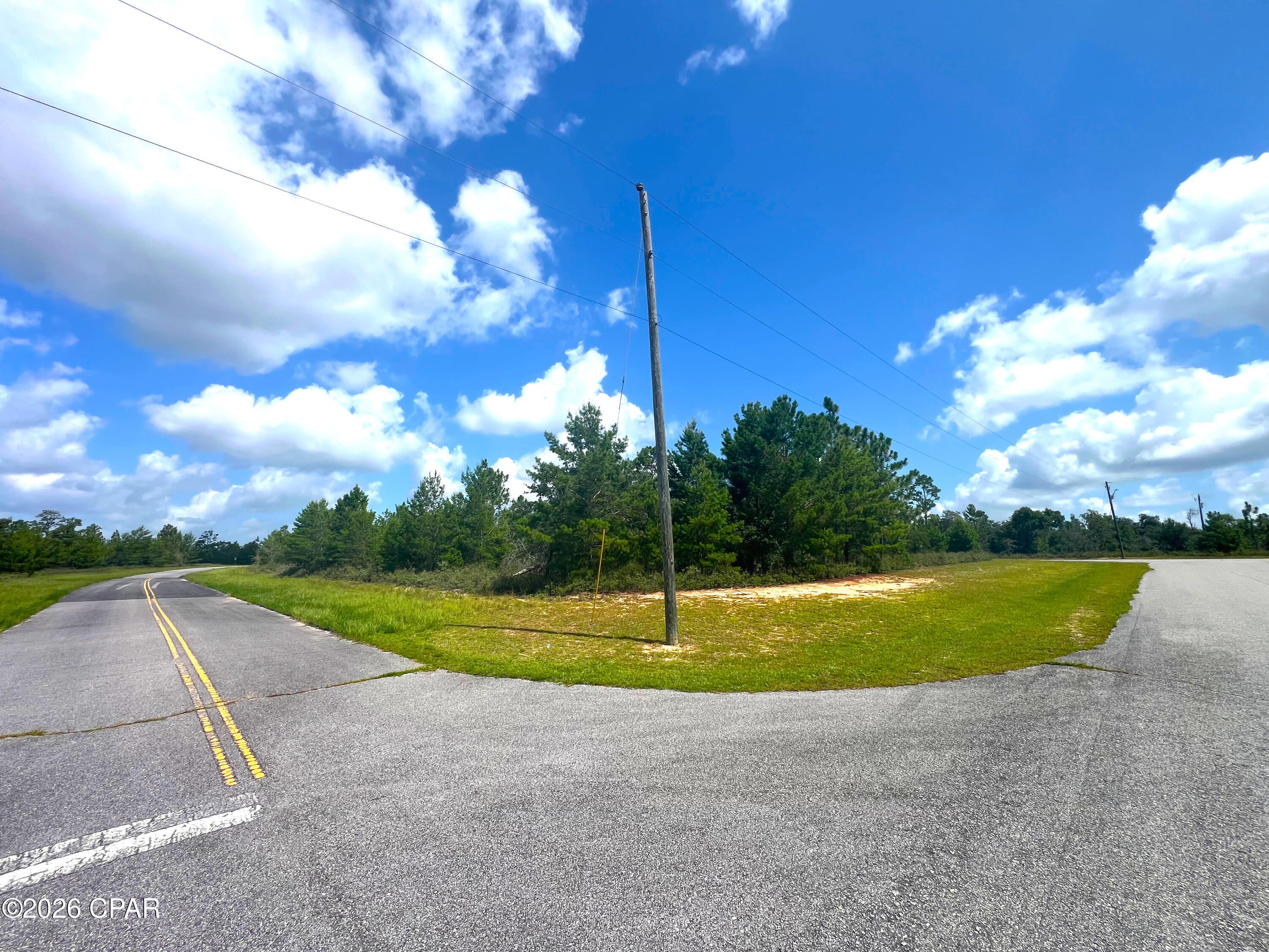 This beautiful corner lot is located in a prime location in beautiful Sunny Hills! This part of Sunny Hills has not yet been bought up by developers, in spite of the high quality roads and proximity to the Public Library. Enjoy a quiet neighborhood nestled amongst rolling hills and beautiful scenery. This section of Sunny Hills is a cyclist's dream, and a great place to raise children. Sunny Hills is undergoing a revival, with lots of new houses being built. This particular lot is lightly wooded, with great access, and would be easy to develop. It sits only 0.3 miles from the Public Library, and 1.4 miles from the pristine Boat Lake Recreation Area. Sunny Hills has churches, a popular golf course, and spring fed lakes with white sand beaches. Enjoy peaceful recreation in the Florida panhandle without fighting the crowds and traffic! Panama City and Panama City Beach are both a short commute for work or leisure.